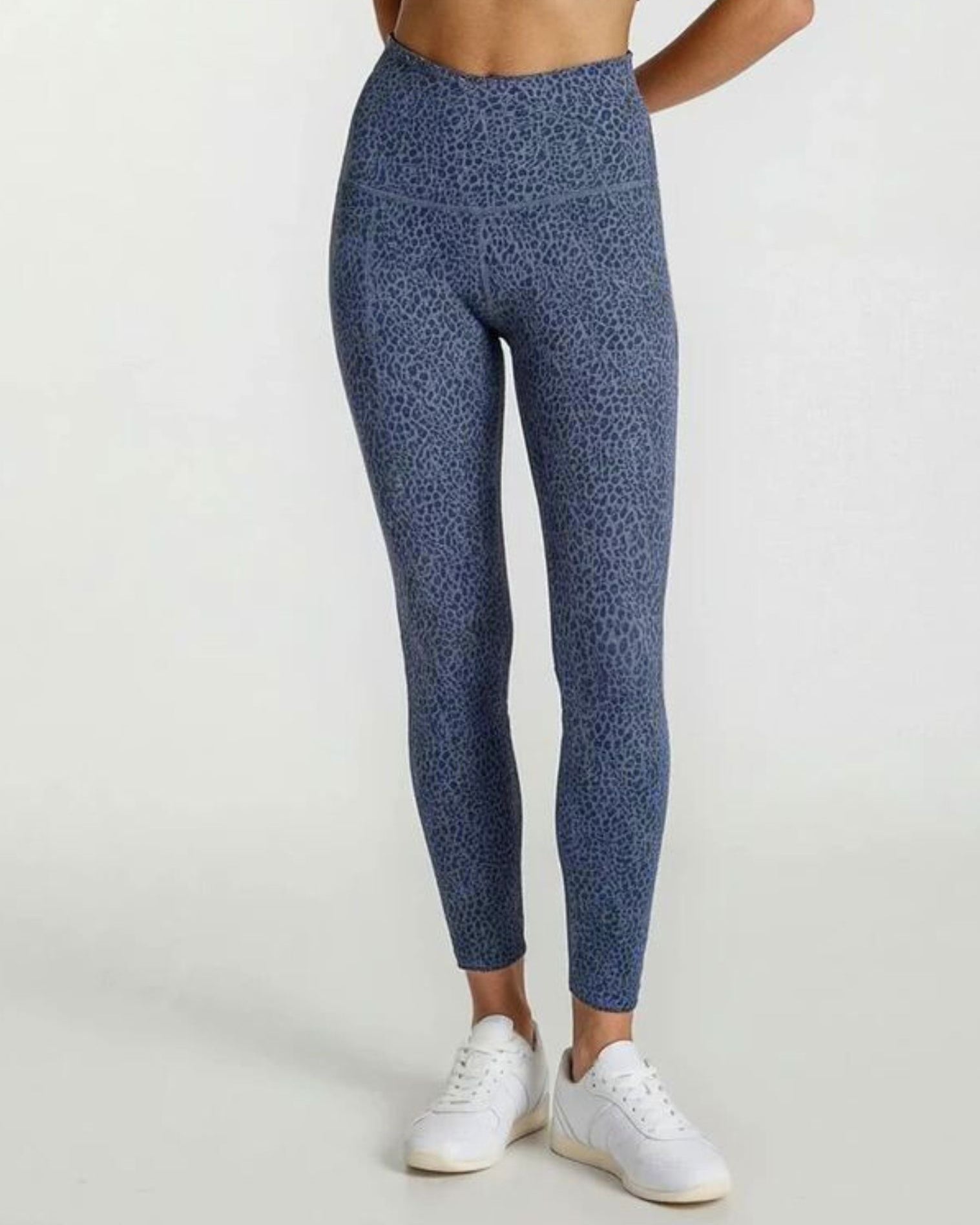 Person wearing blue patterned leggings Teal Blue Paw Print Bamboo Swift Cross Leg Legging Super Soft Breathable Hypoallergenic_ by Active by GS on a white background