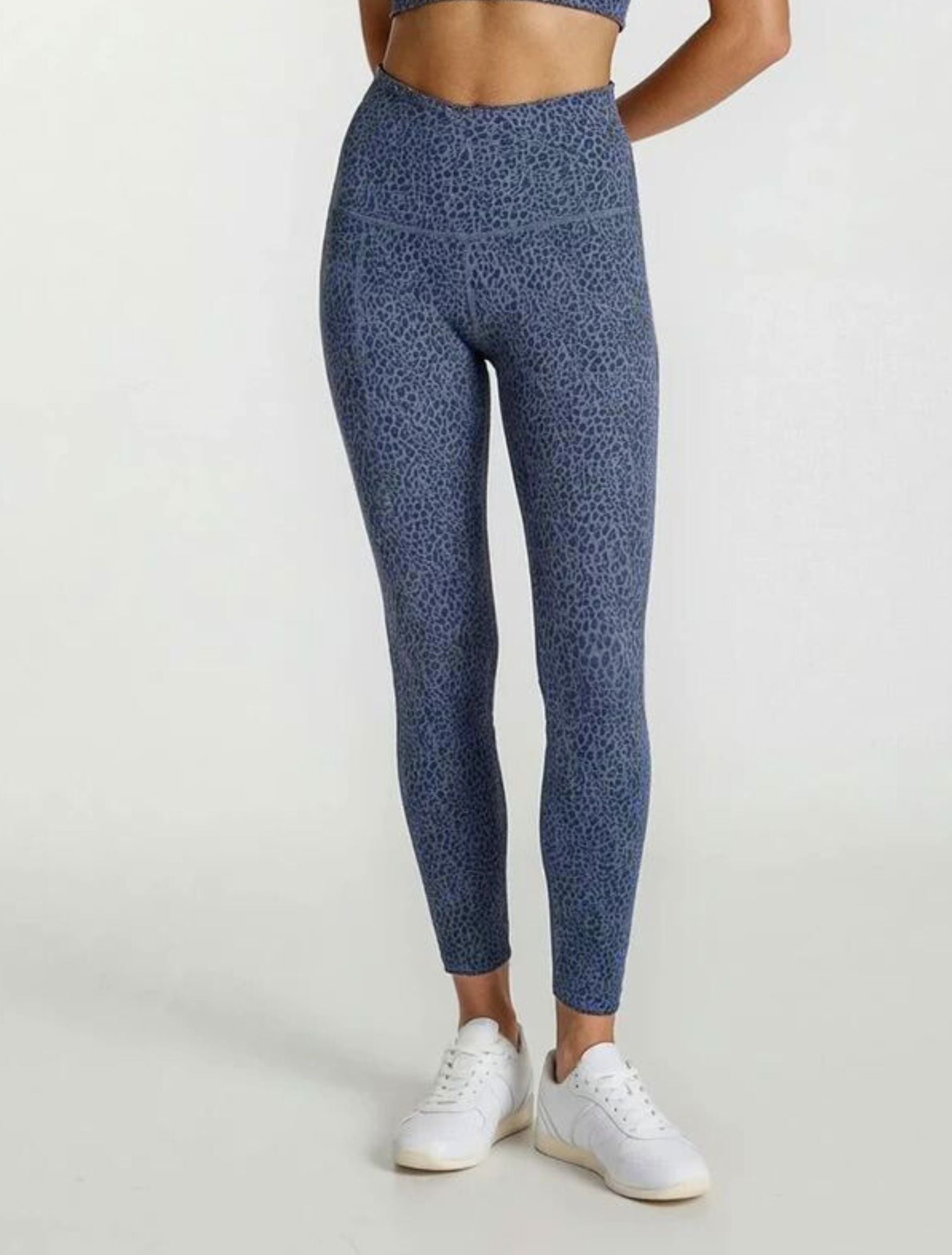 Person wearing blue patterned leggings Teal Blue Paw Print Bamboo Swift Cross Leg Legging Super Soft Breathable Hypoallergenic_ by Active by GS on a white background