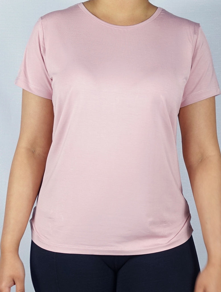 Woman wearing a super soft pink crew neck tee shirt