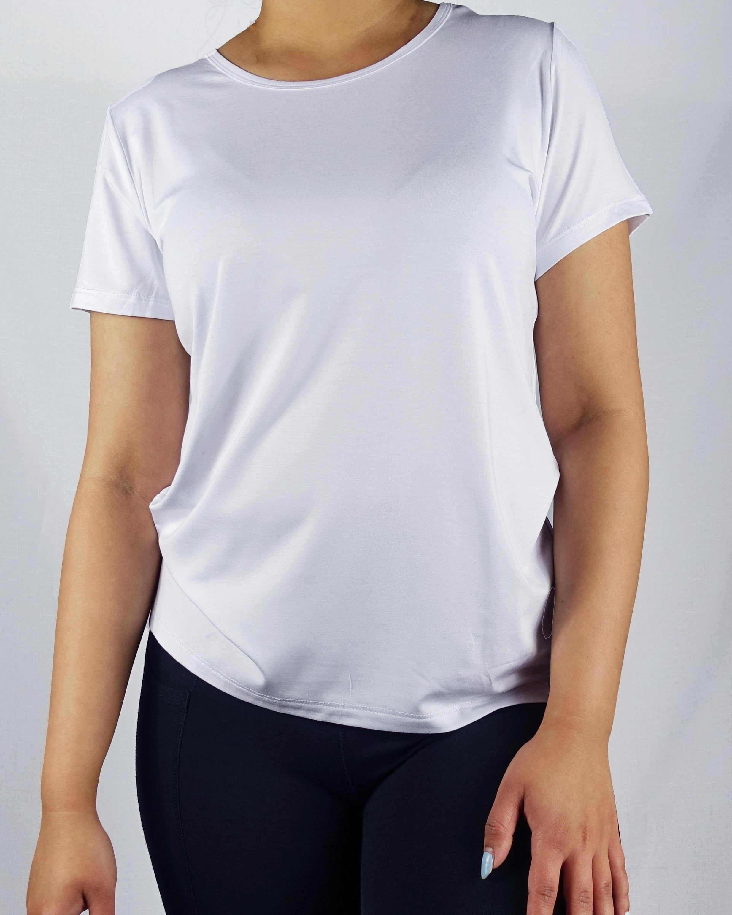 Front view of a white crew neck tee shirt on a model