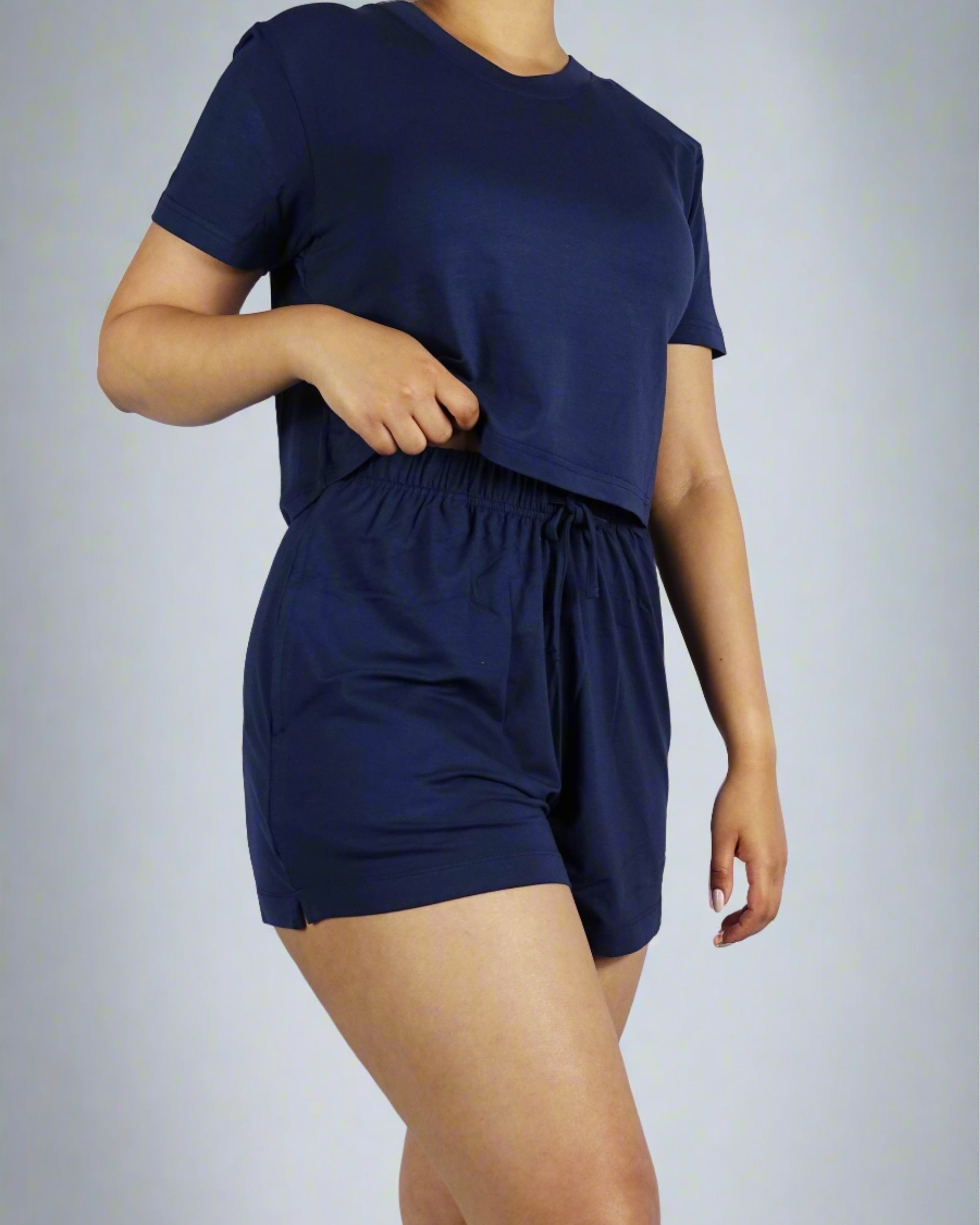 A woman wearing a navy crop tee with round neck and short sleeve