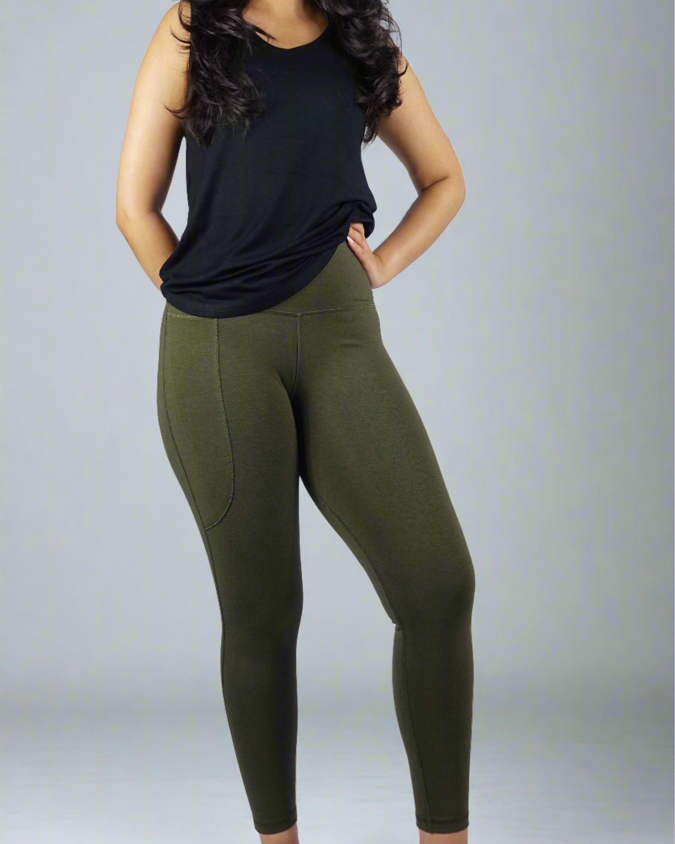 Woman wearing a black sleeveless tank top with a round neck