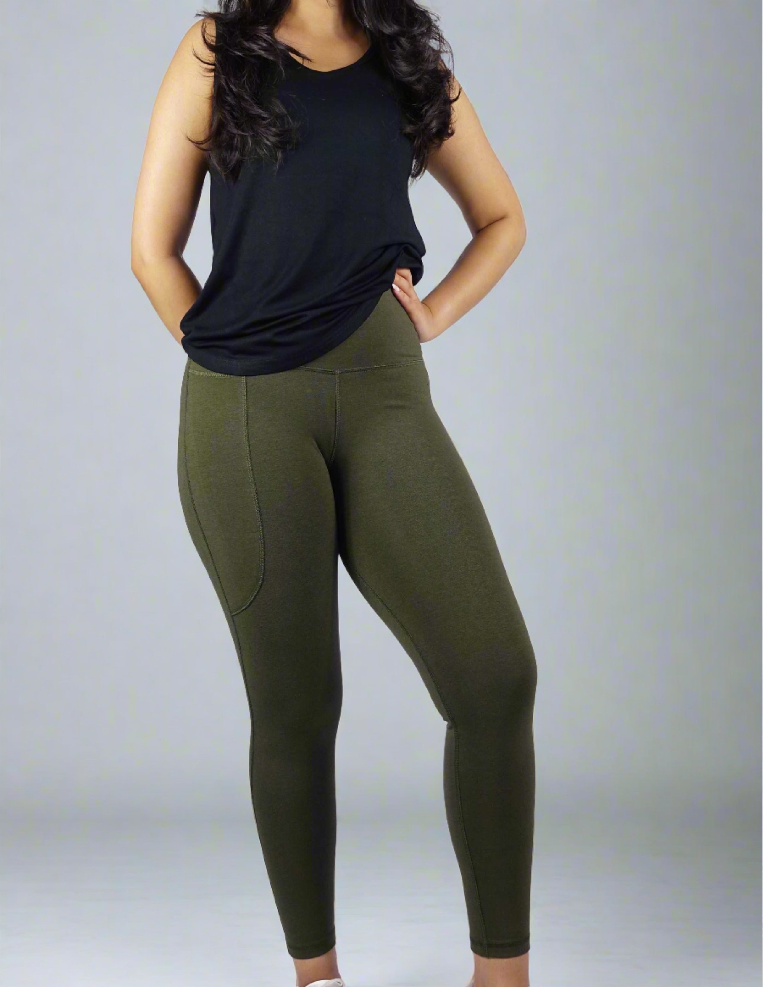 Woman wearing a black sleeveless tank top with a round neck