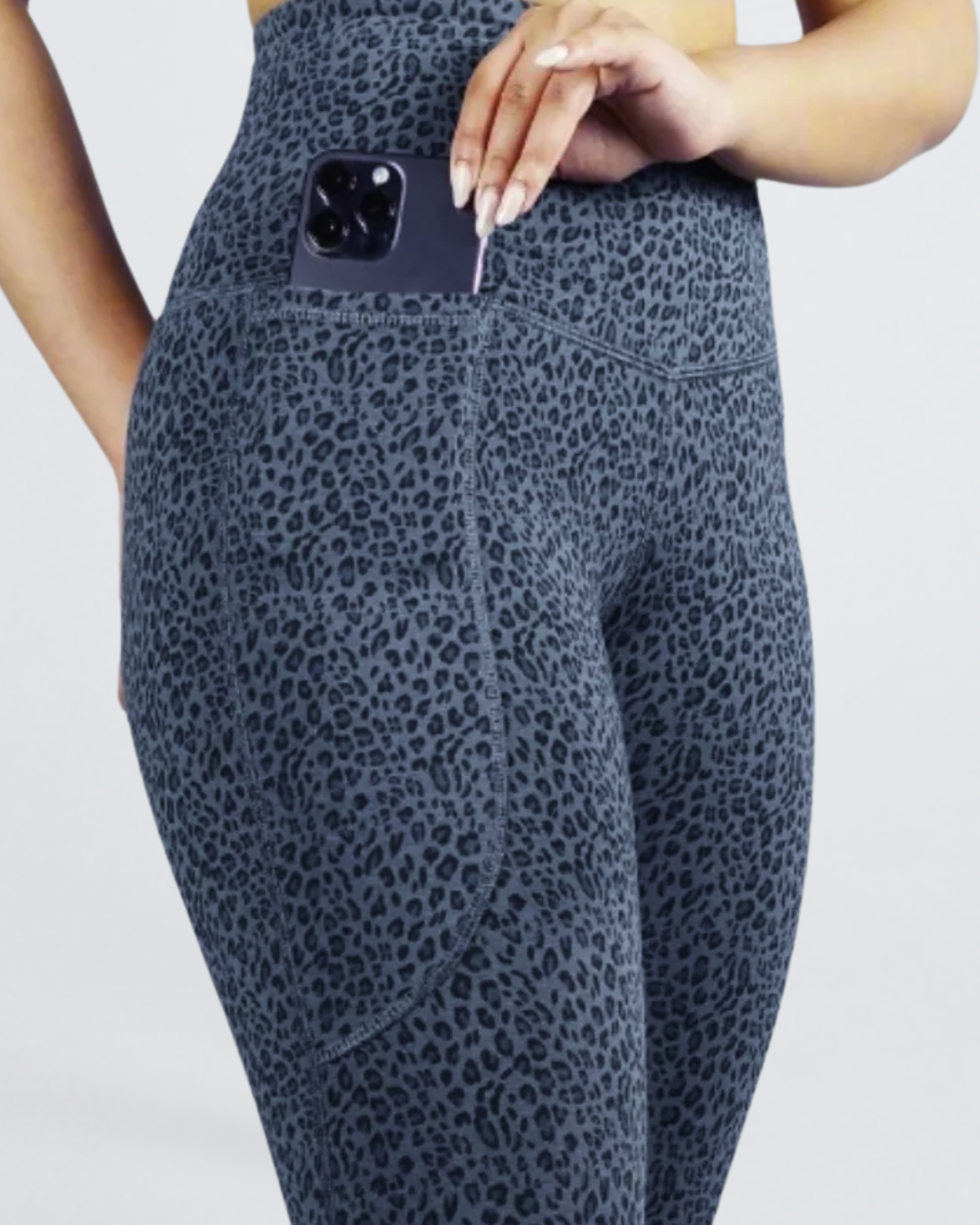 Women's Super Super Soft Bamboo Tights Leopard print leggings with a pocket holding a phone on a light gray background