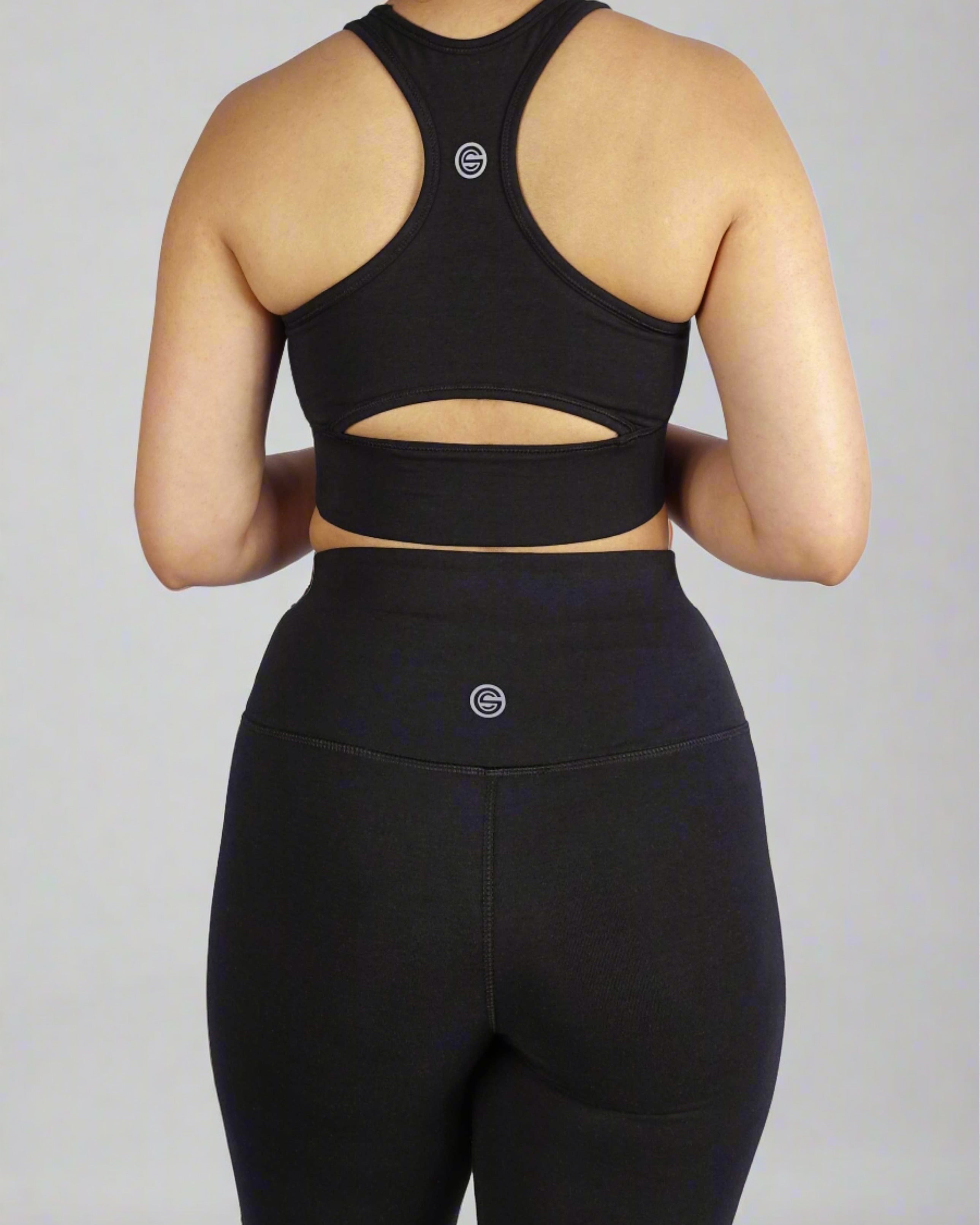 Back view of black sports bra with keyhole cut and side panel stitch for comfort