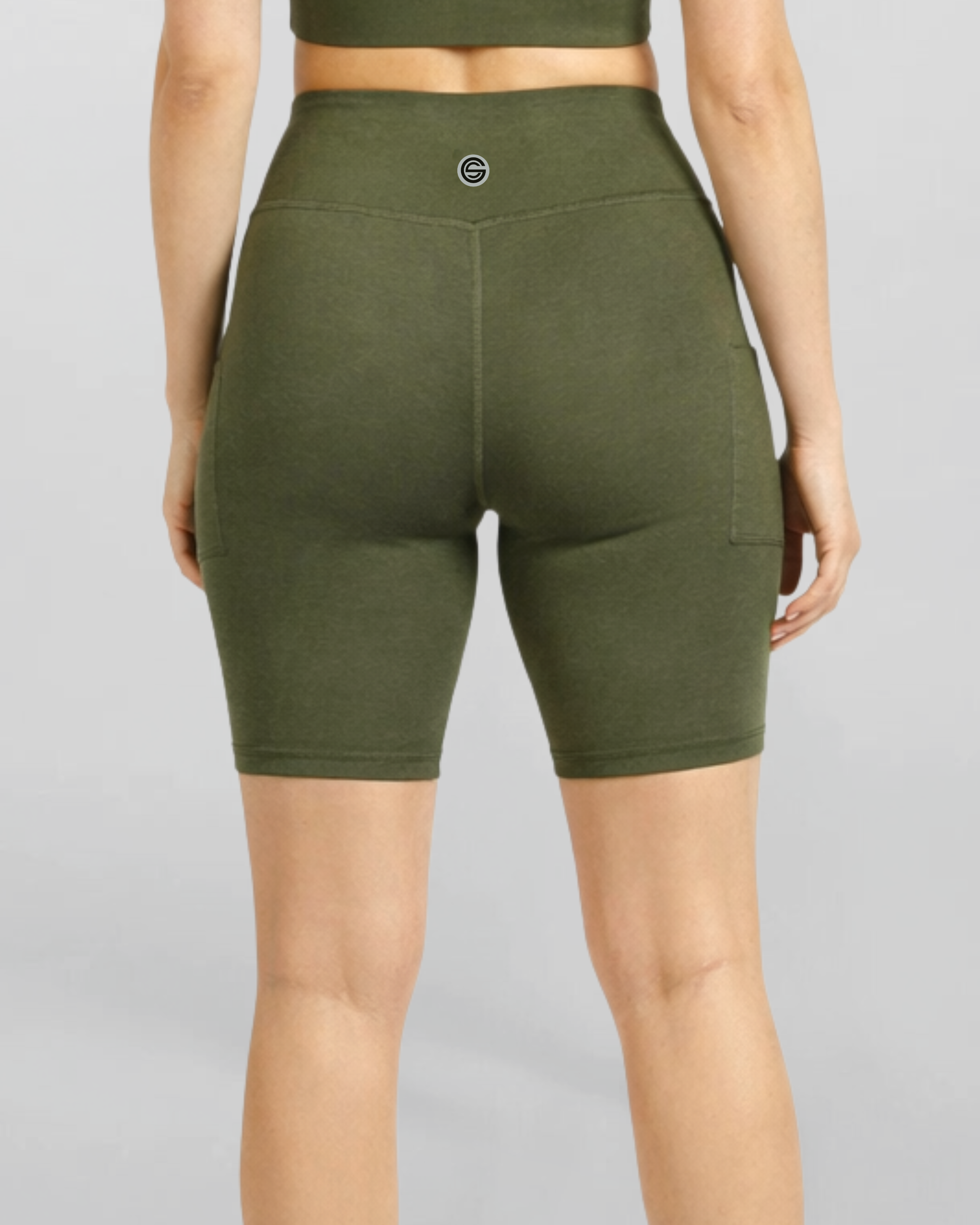 Womens no see Motion Khaki Bike Shorts Bamboo soft and moisture wicking performance gym yoga pilates short Green athletic shorts worn by a person on a gray background