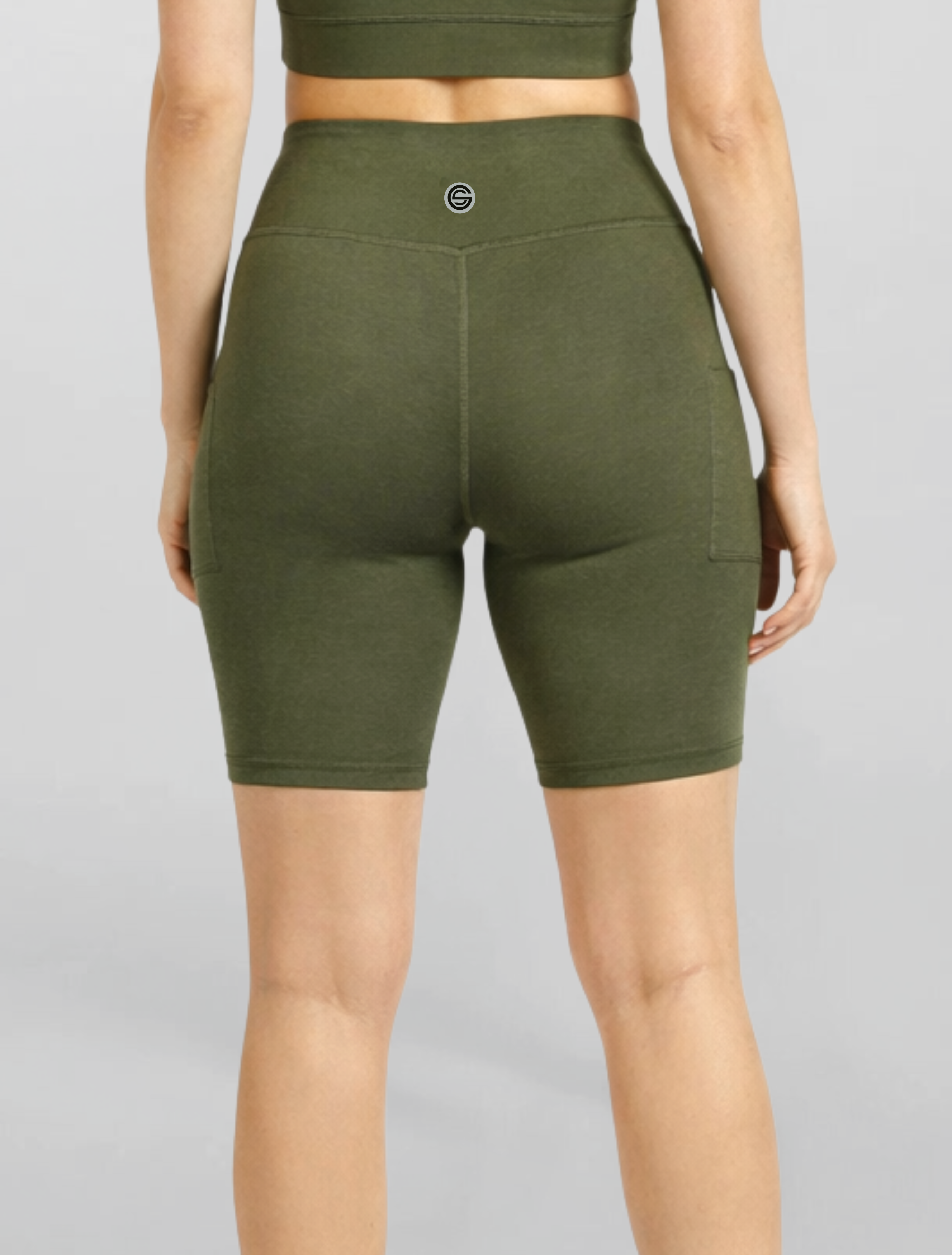 Womens no see Motion Khaki Bike Shorts Bamboo soft and moisture wicking performance gym yoga pilates short Green athletic shorts worn by a person on a gray background