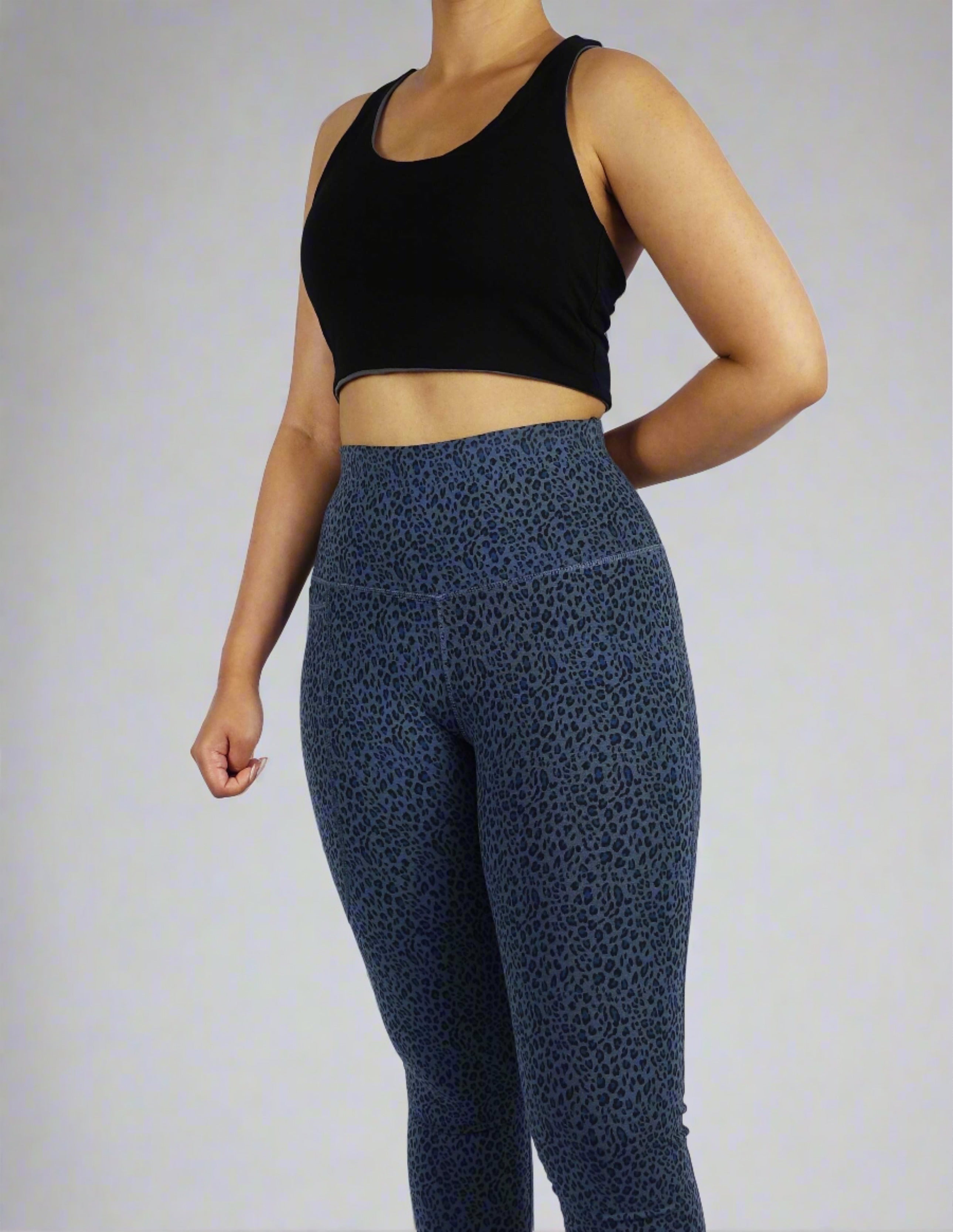 Model wearing black and grey reversible crop top showing black side