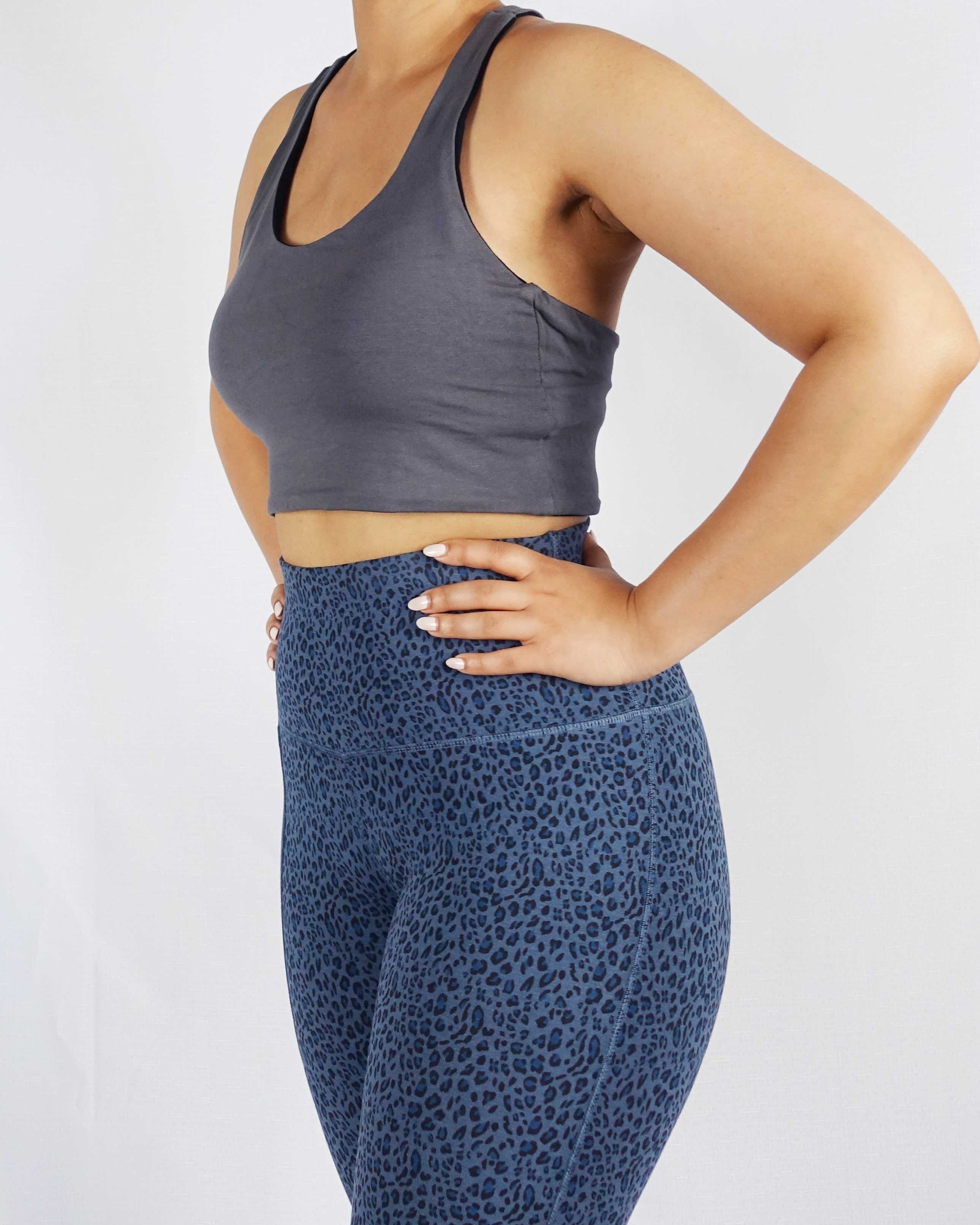 Model wearing grey side of black and grey reversible crop top