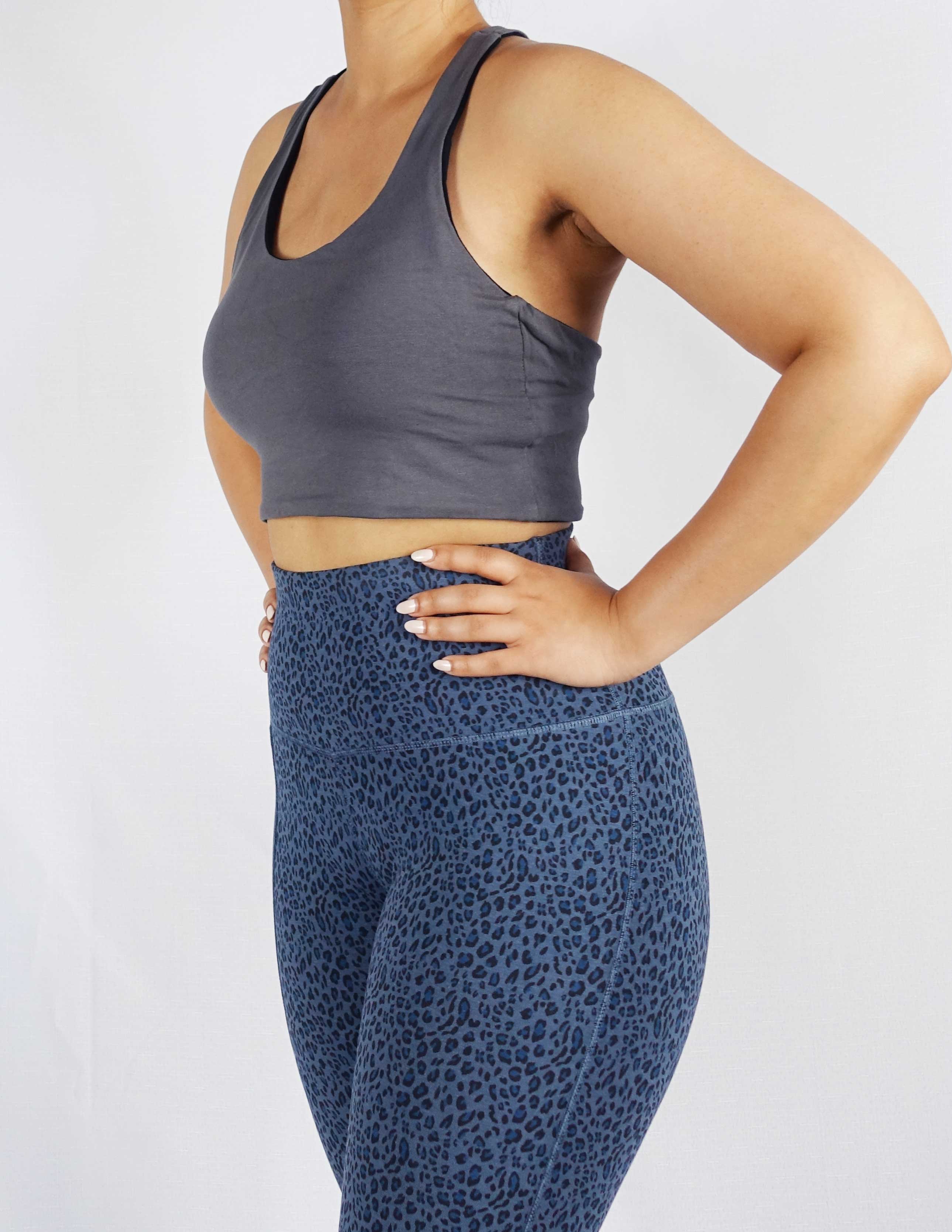 Model wearing grey side of black and grey reversible crop top