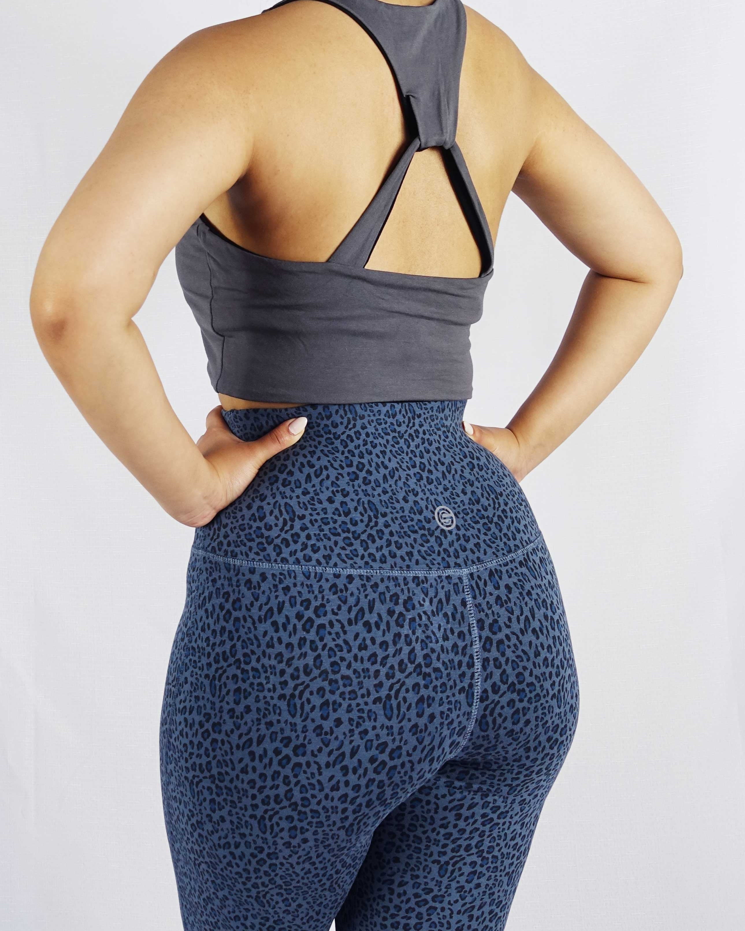 Back view of model wearing grey side of black and grey reversible crop top
