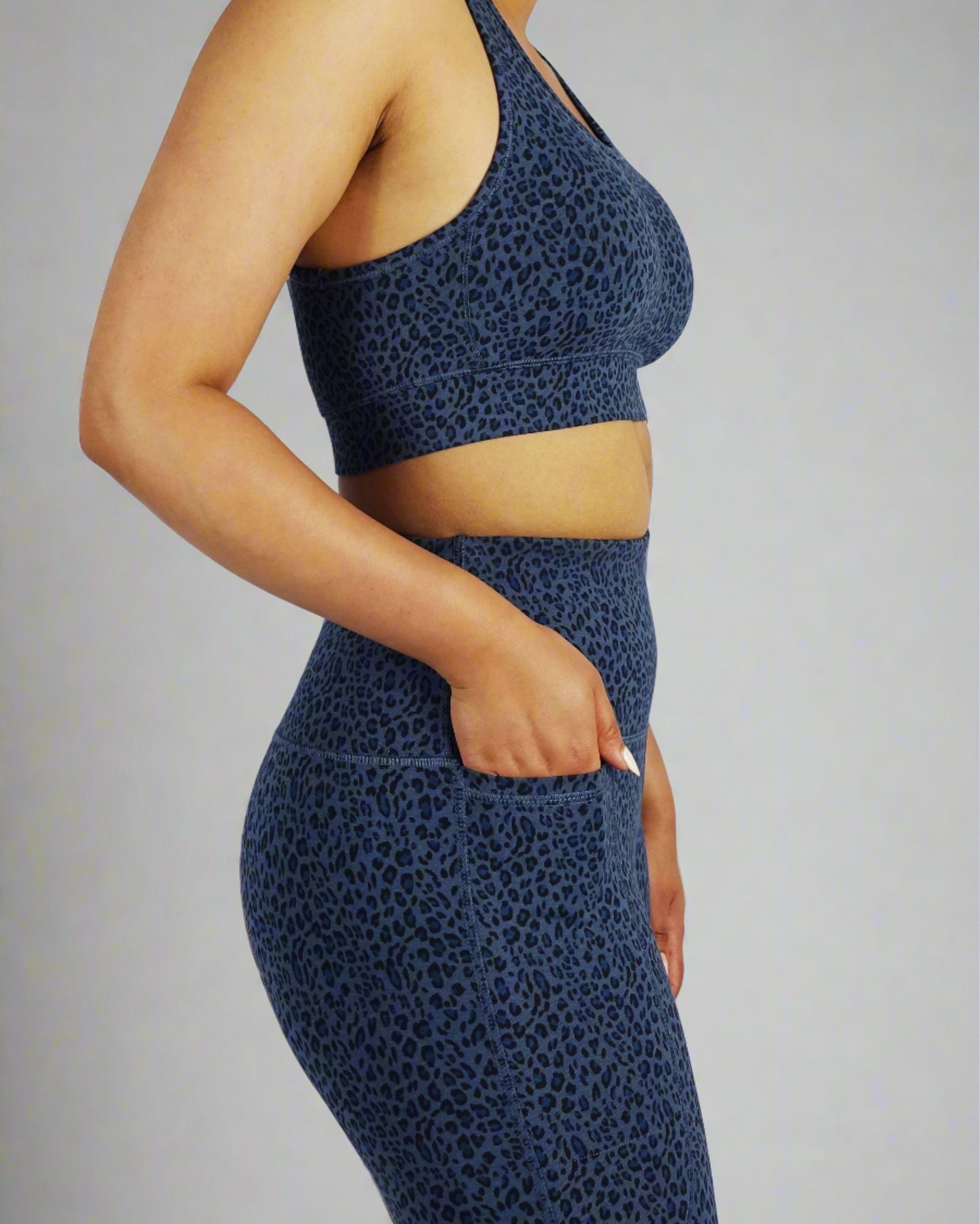 Side view of model wearing blue leopard print sports bra