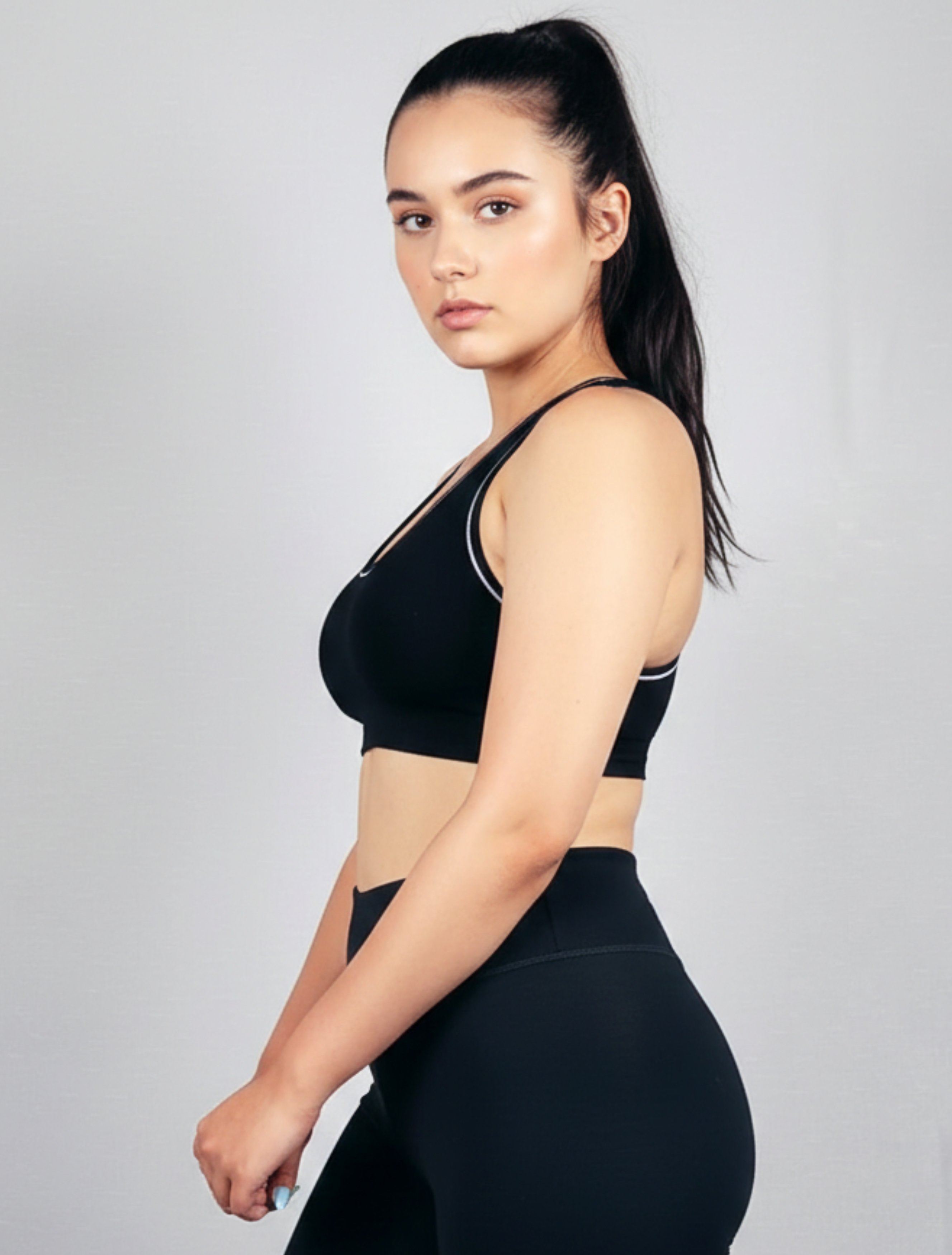 Woman wearing a black sports bra and leggings Womens Black ribbed-seamless-wirefree-bra-Bamboo super soft hypoallergenic breathable on a gray background