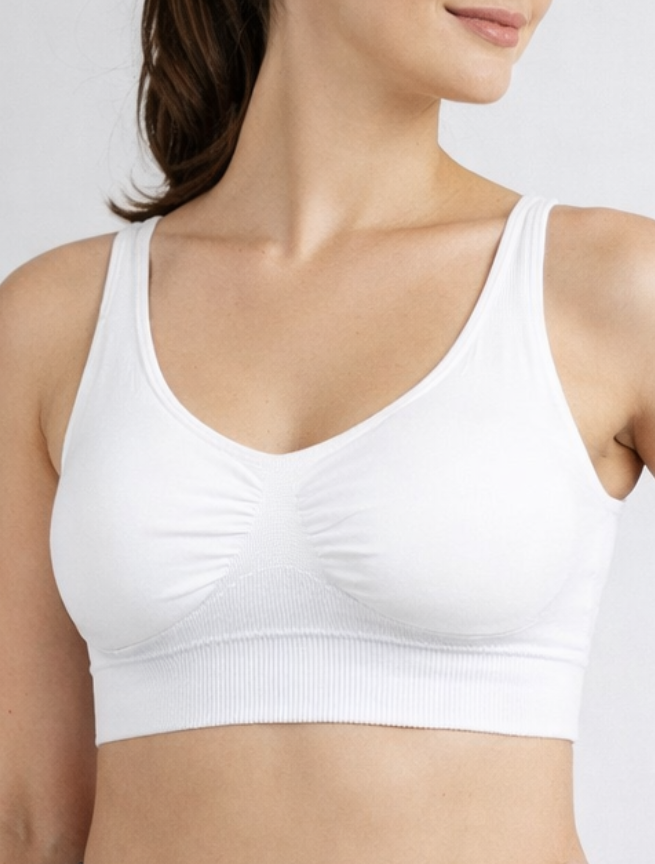 Bamboo Super soft Women's White seamless sports bralette worn by a woman on a plain background