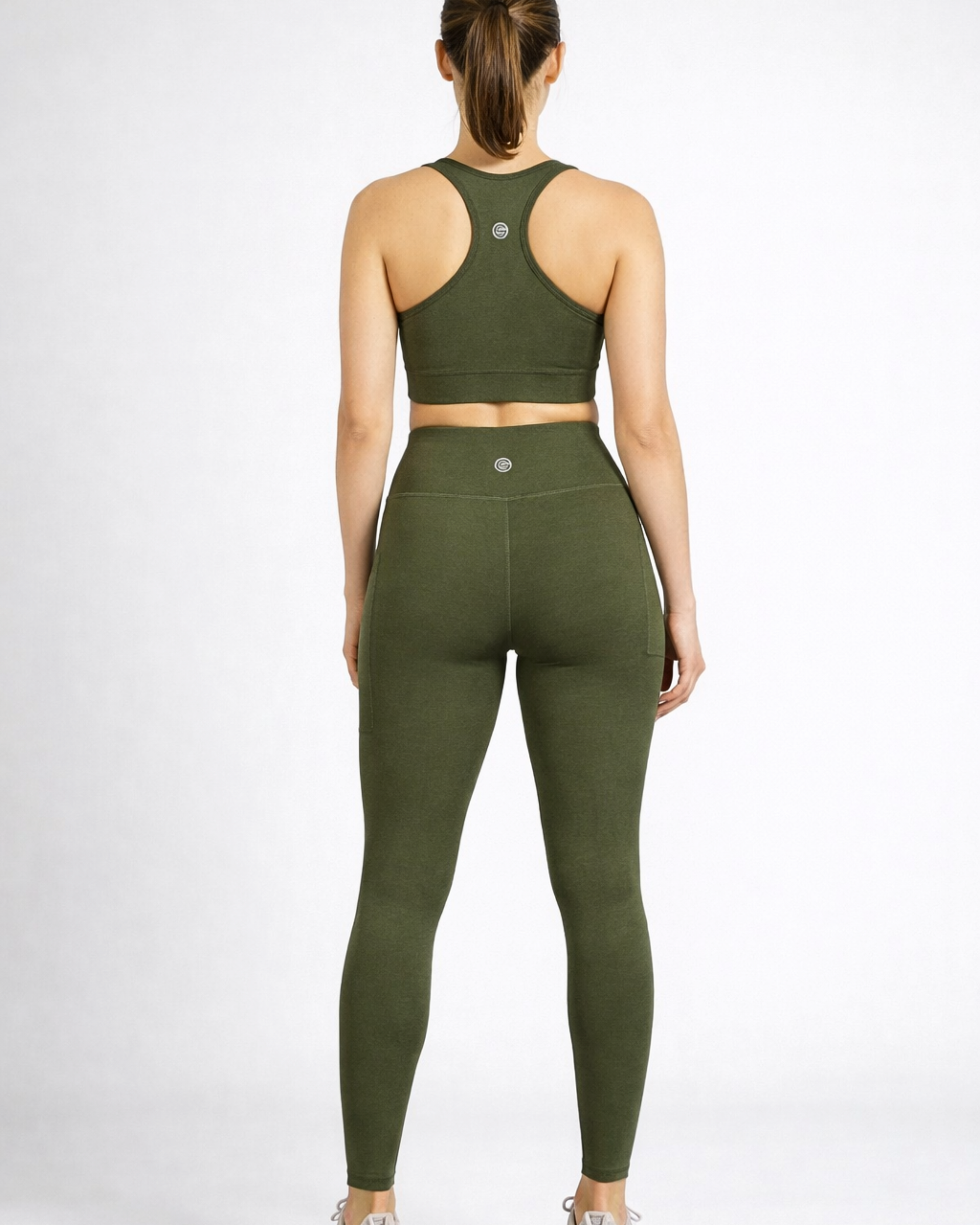 Person wearing an olive green khaki athletic outfit bamboo-athleisure-leggings and sports bra australia_activebygs on a white background