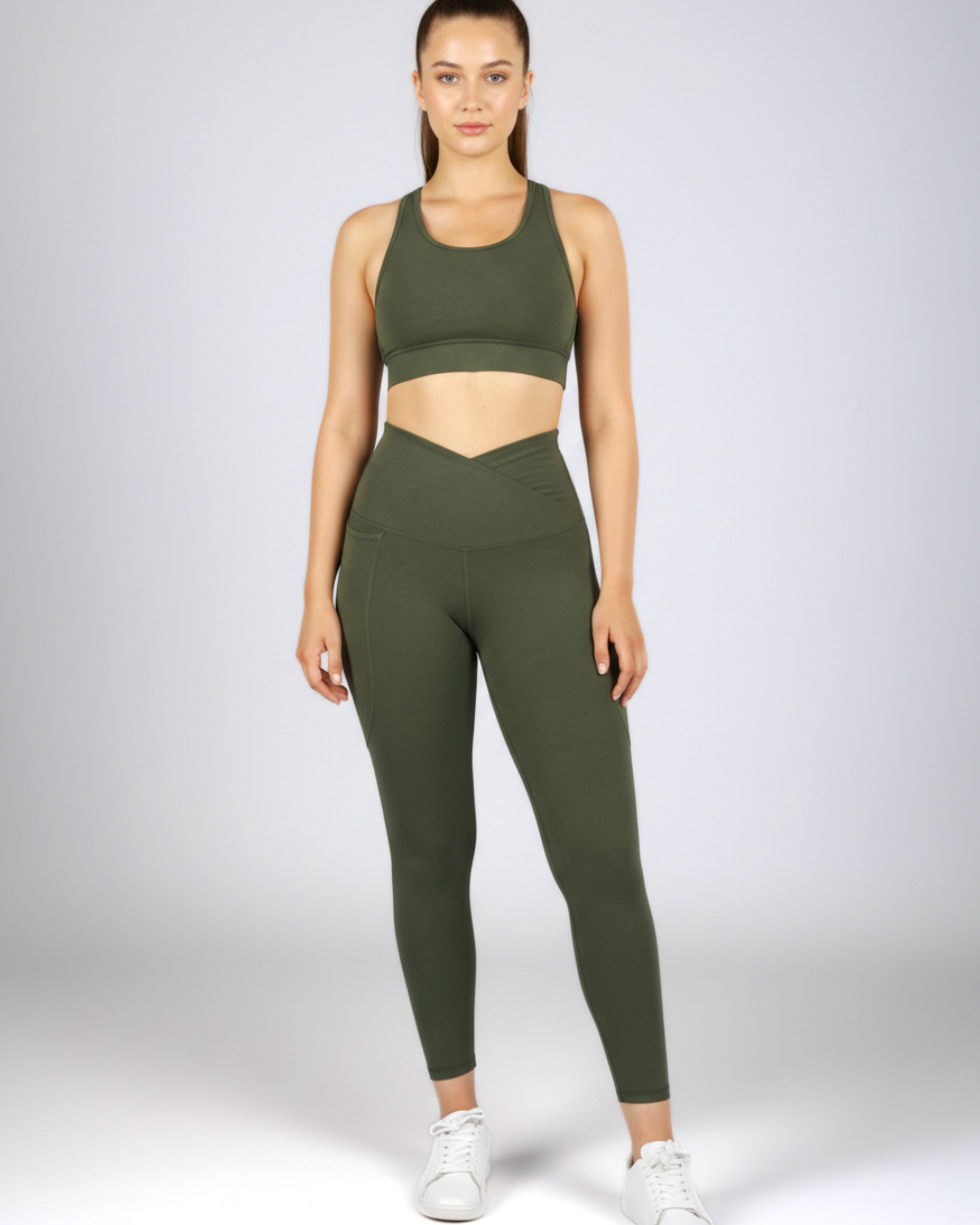 Olive green crossover waist gym leggings with a flattering V-shaped waistband, offering compression support and flexible movement.