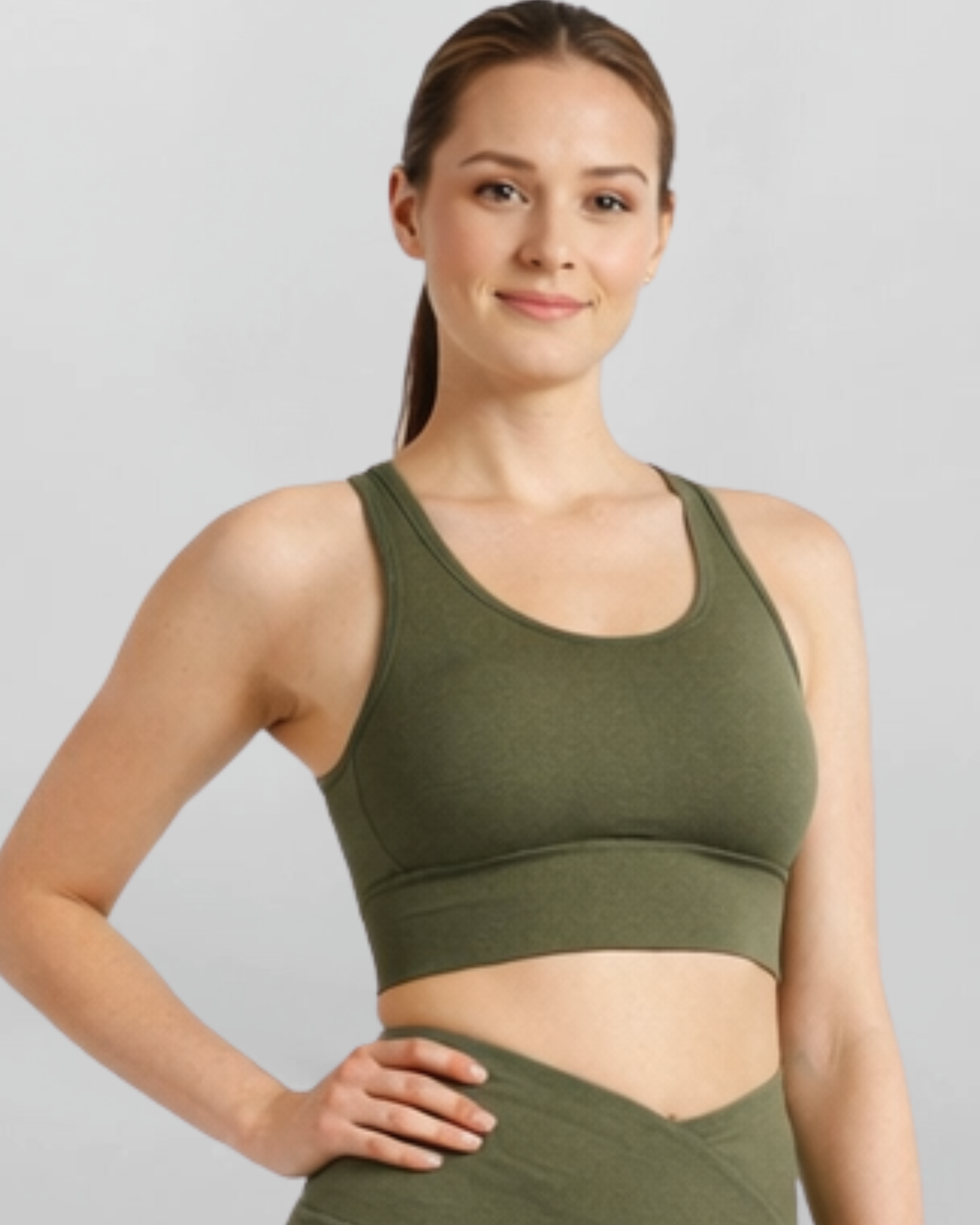 Woman wearing an olive green khaki high support sports bra bamboo fabric supersoft and breathable on a light gray background