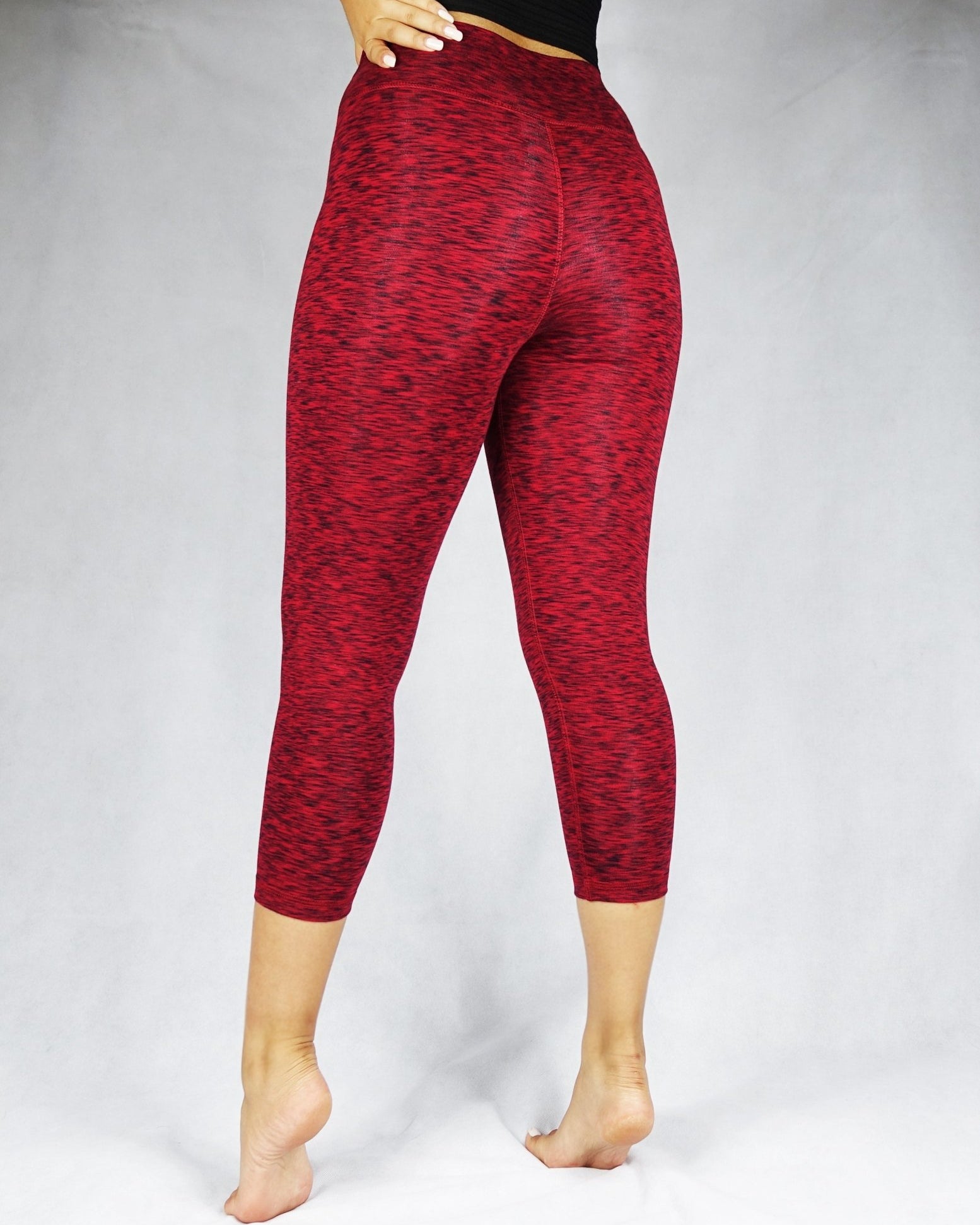 Back view of a woman wearing red crop leggings, activewear