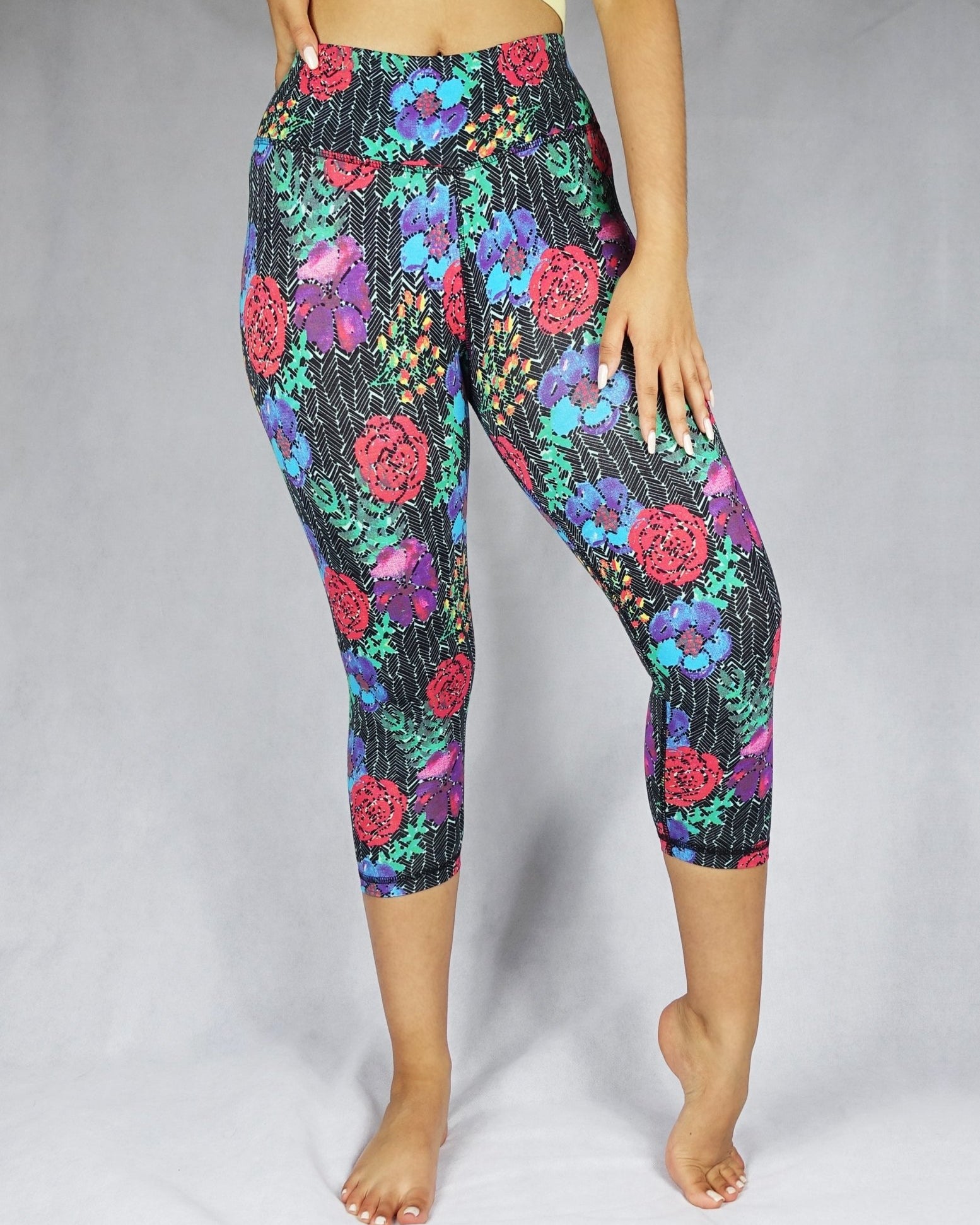 model wearing crop leggings of red, blue and green flowery prints