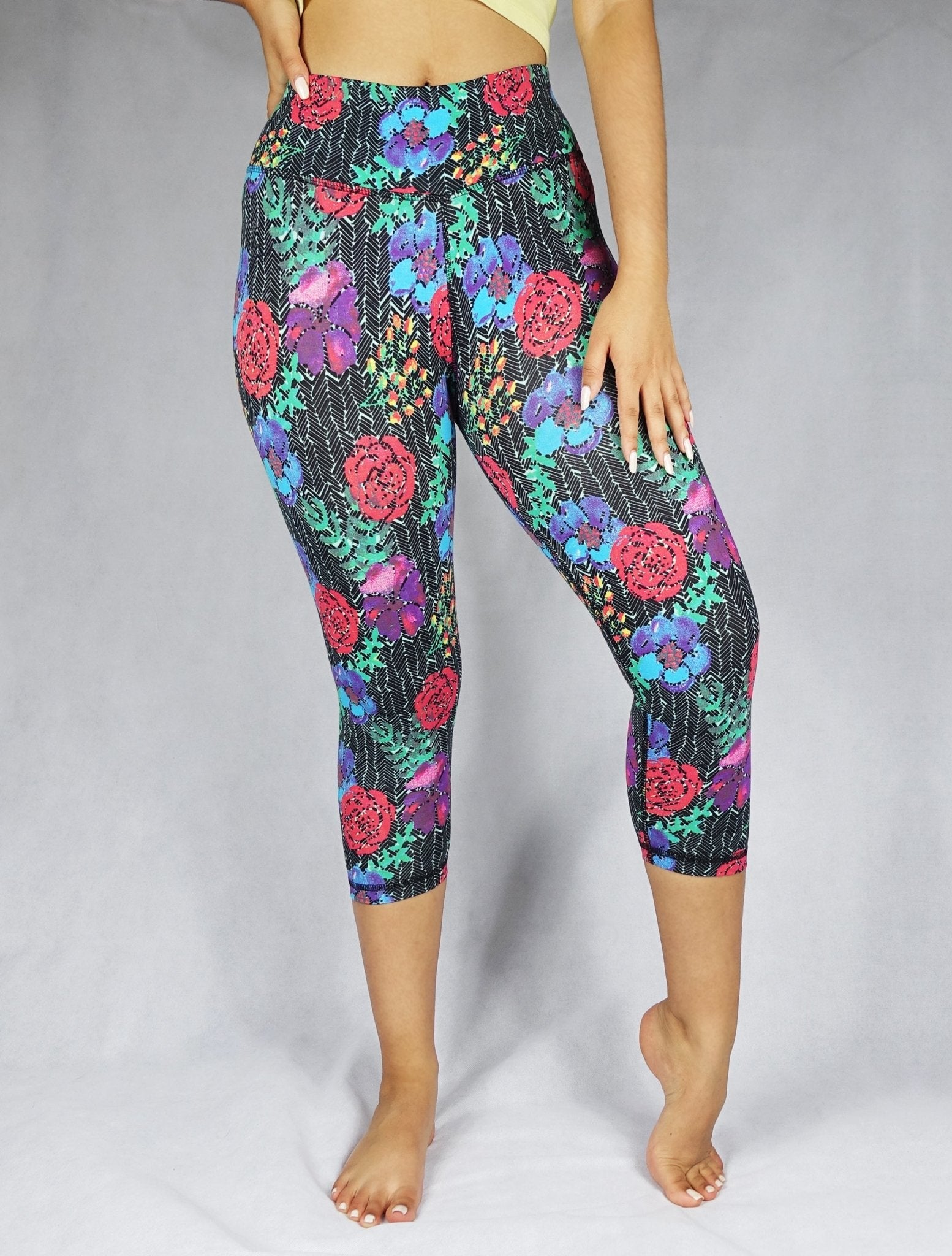 model wearing crop leggings of red, blue and green flowery prints