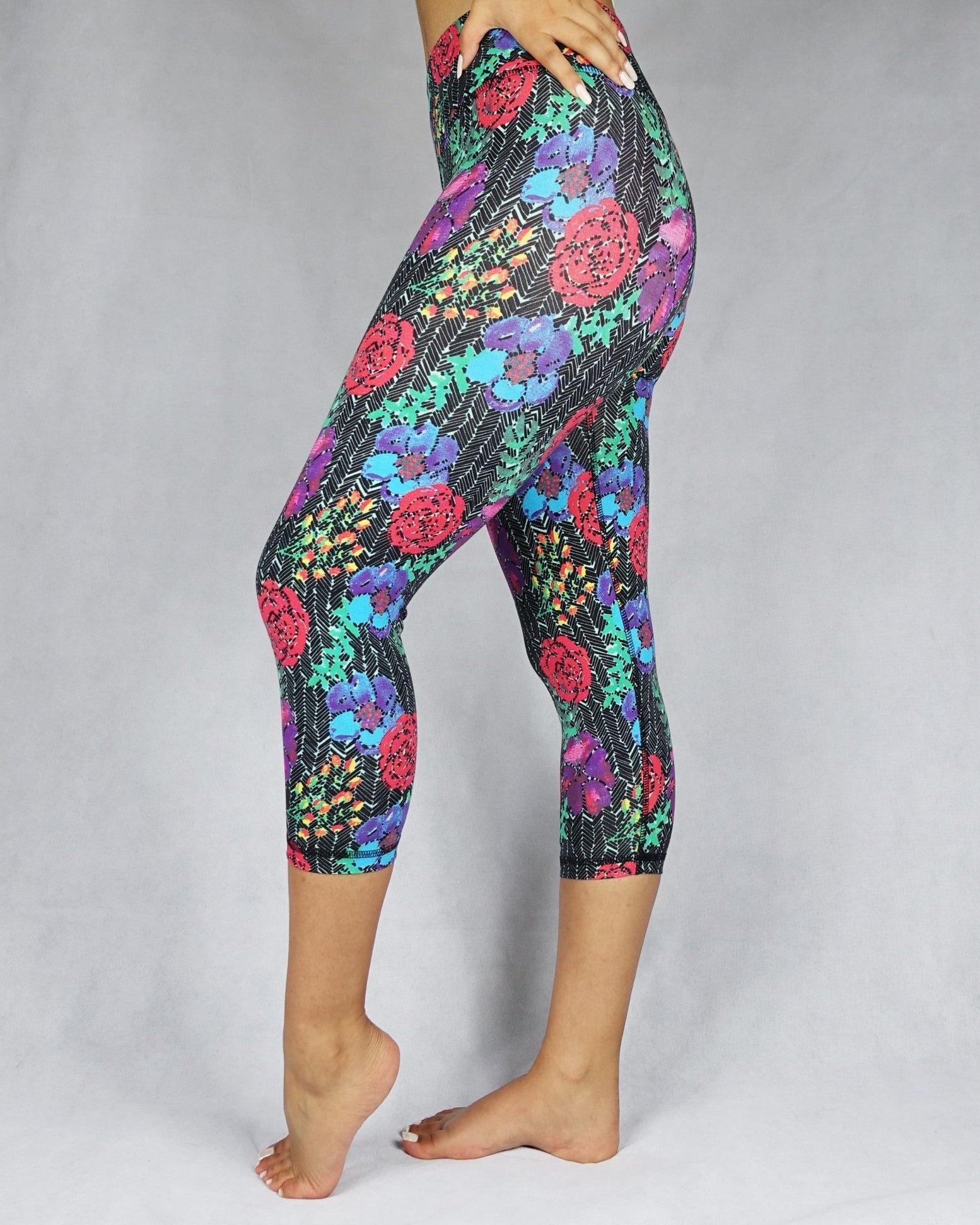 Woman wearing red, blue and green flowery prints of  crop leggings