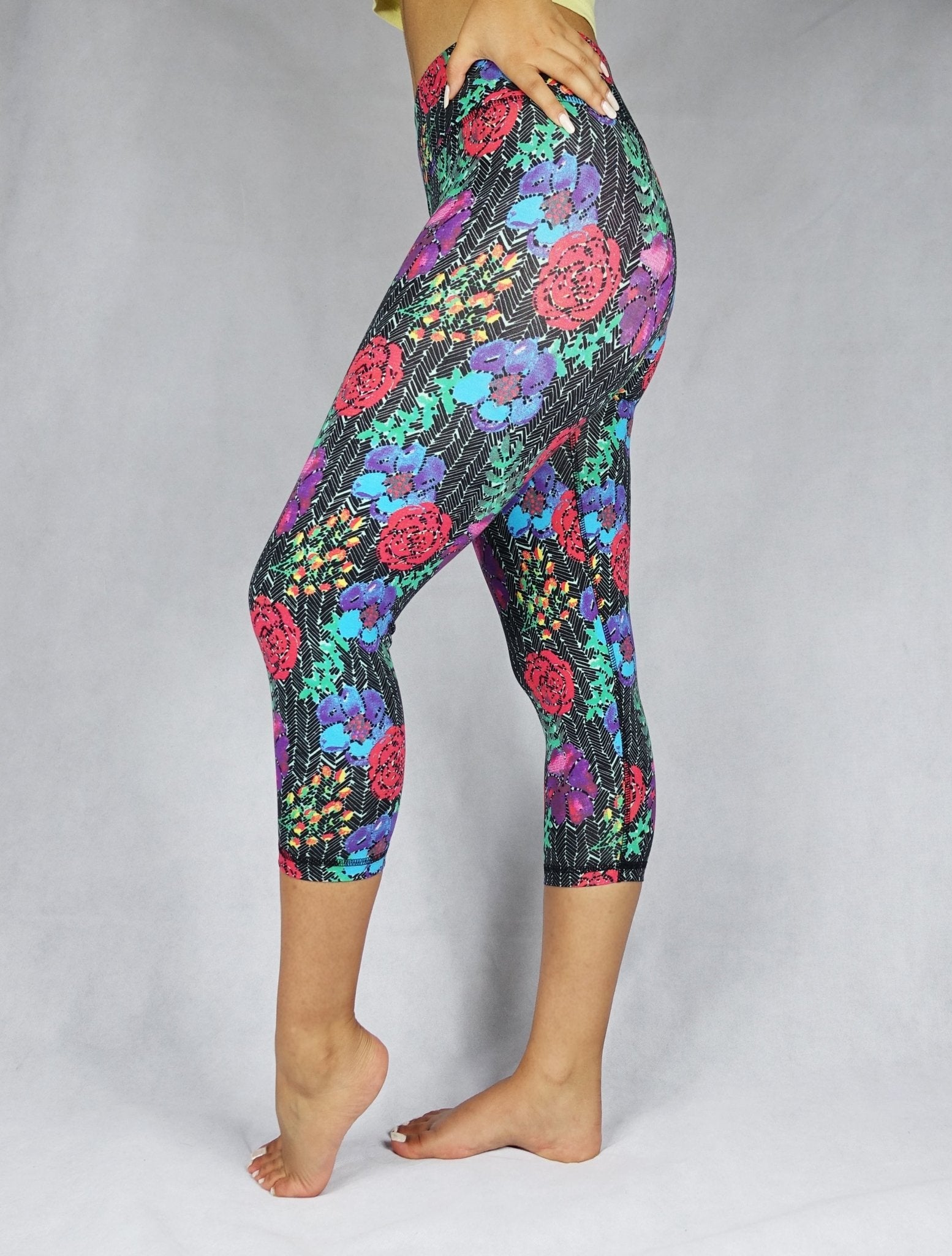 Woman wearing red, blue and green flowery prints of crop leggings