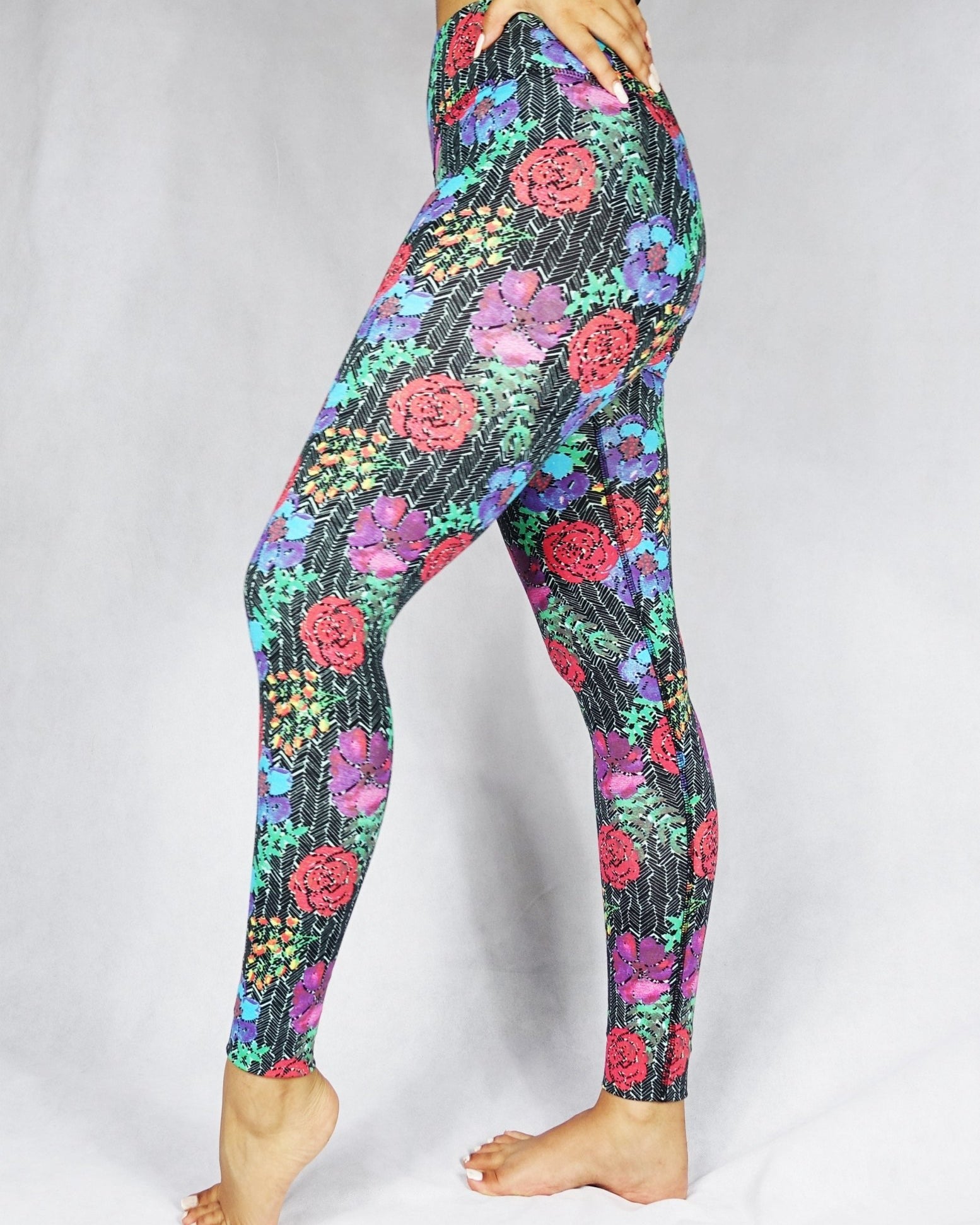 model wearing full length legging with a red, blue and green flowery prints