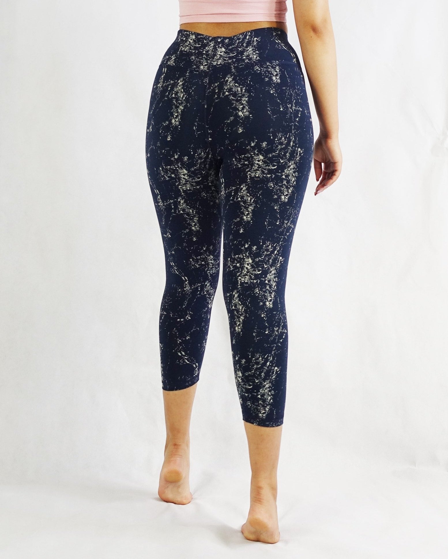 Back view of blue crop leggings with prints