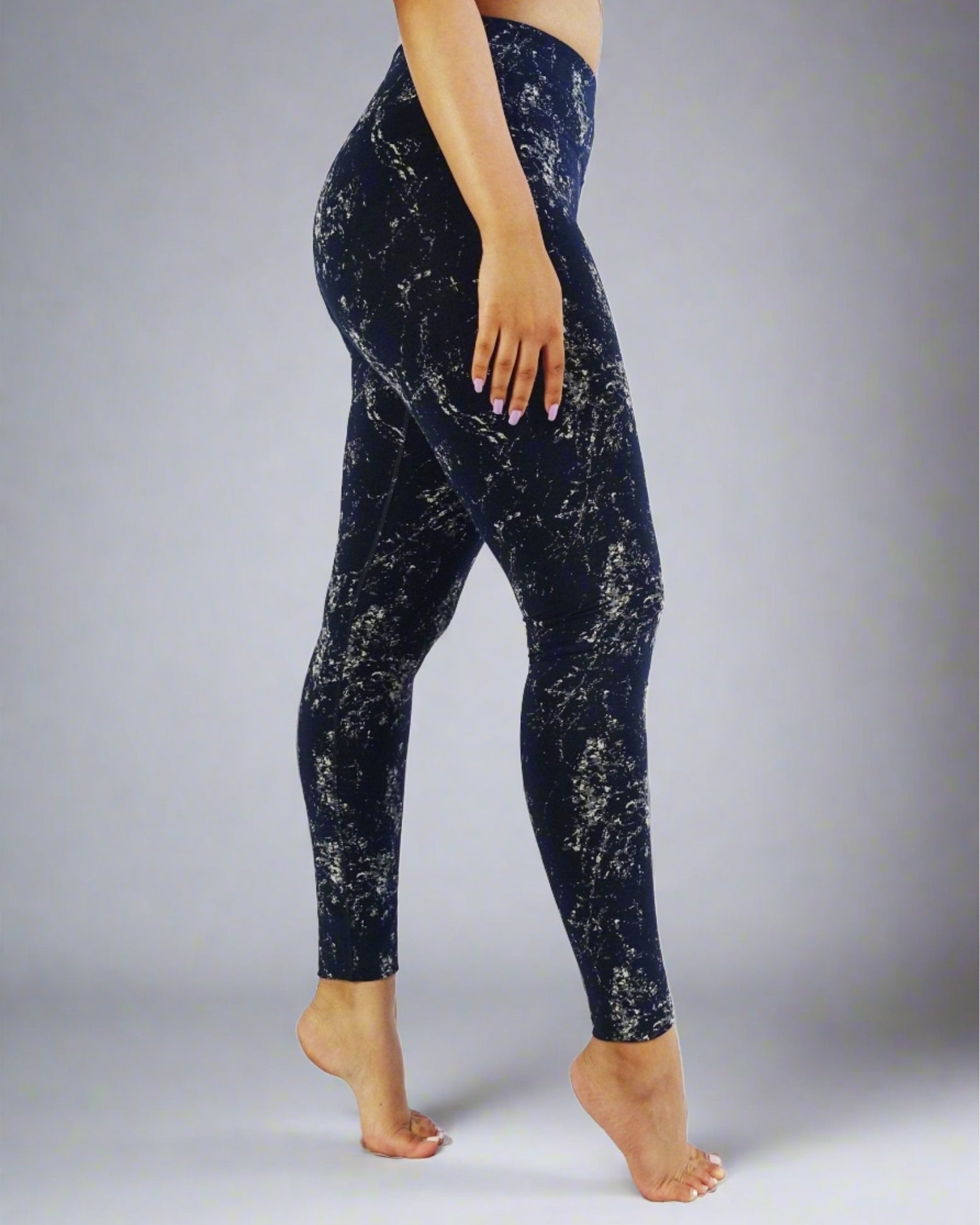 Side view of blue full length leggings with white prints