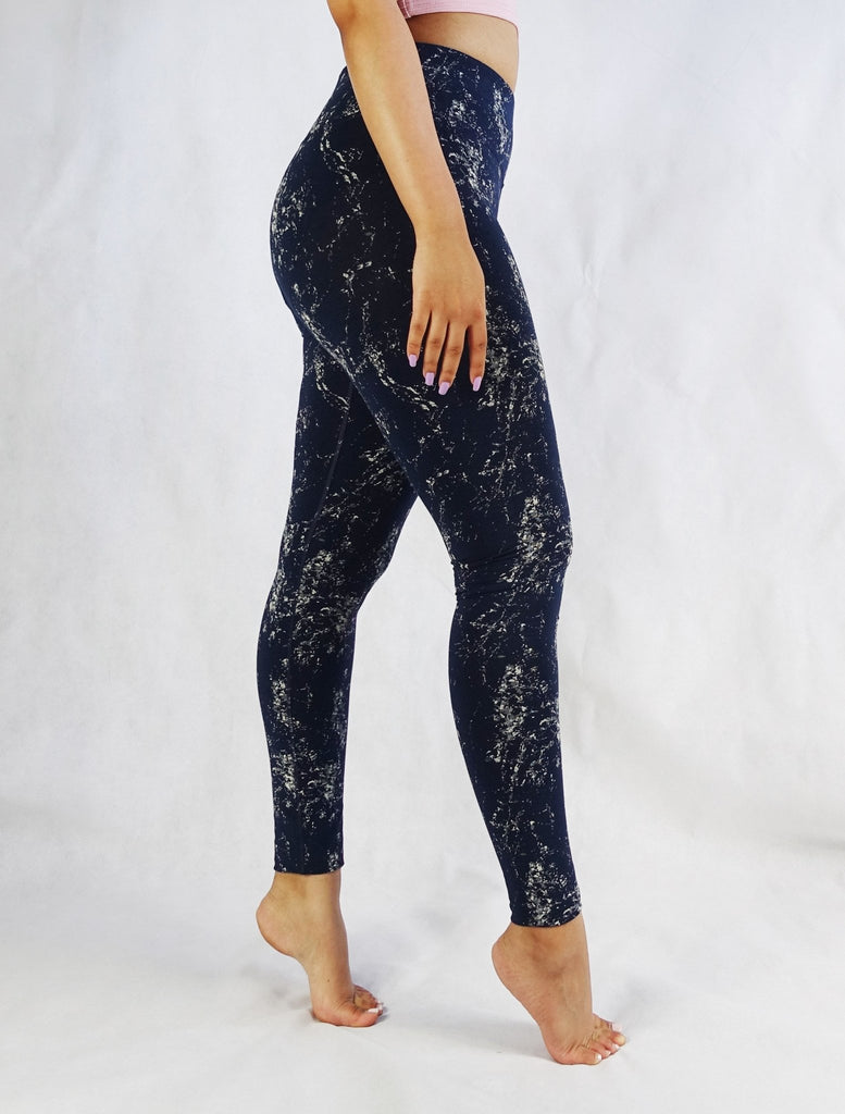 Side view of blue full length leggings with white prints