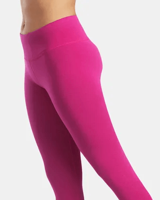 Side view of woman wearing pink full length leggings