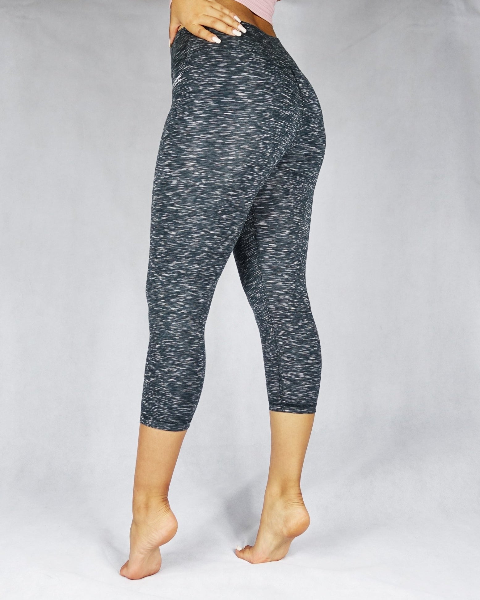 Side view of greyish black crop leggings
