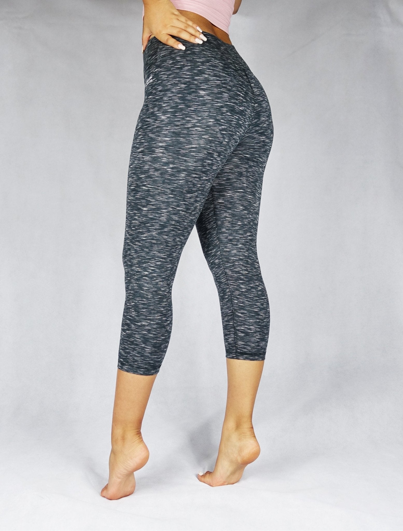 Side view of greyish black crop leggings