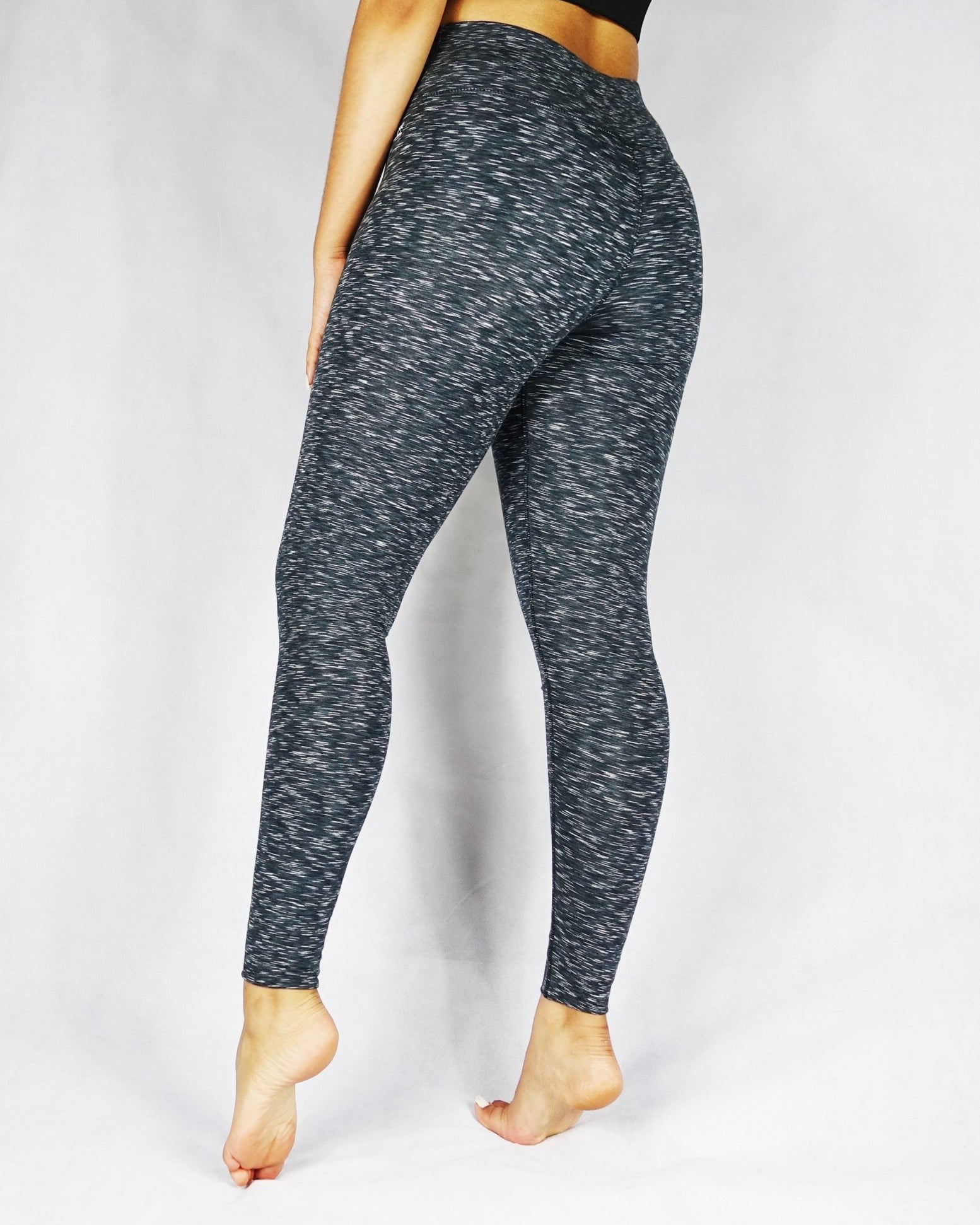 Side back view of greyish black full length leggings