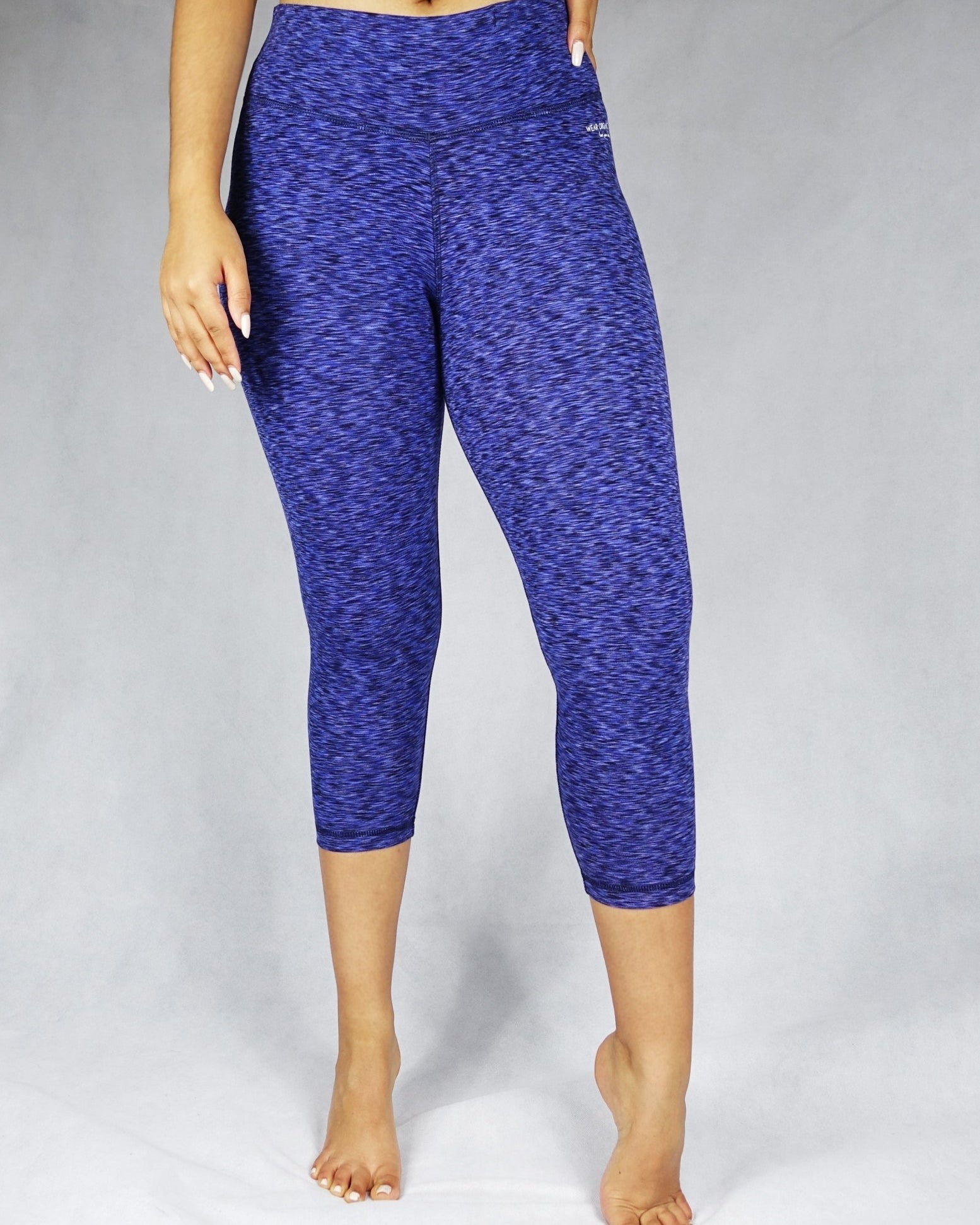 Front view of model wearing blue crop leggings, activewear