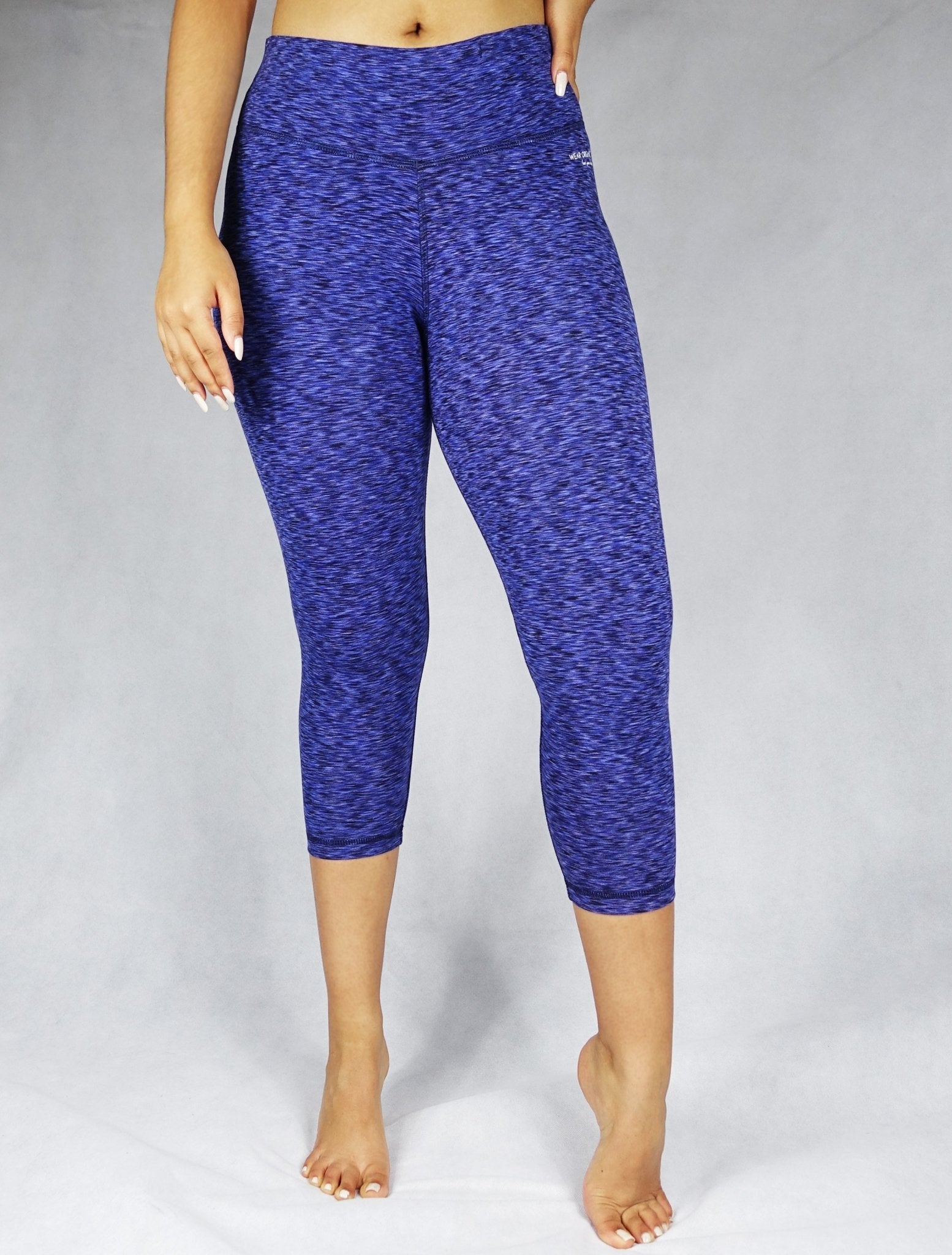 Front view of model wearing blue crop leggings, activewear