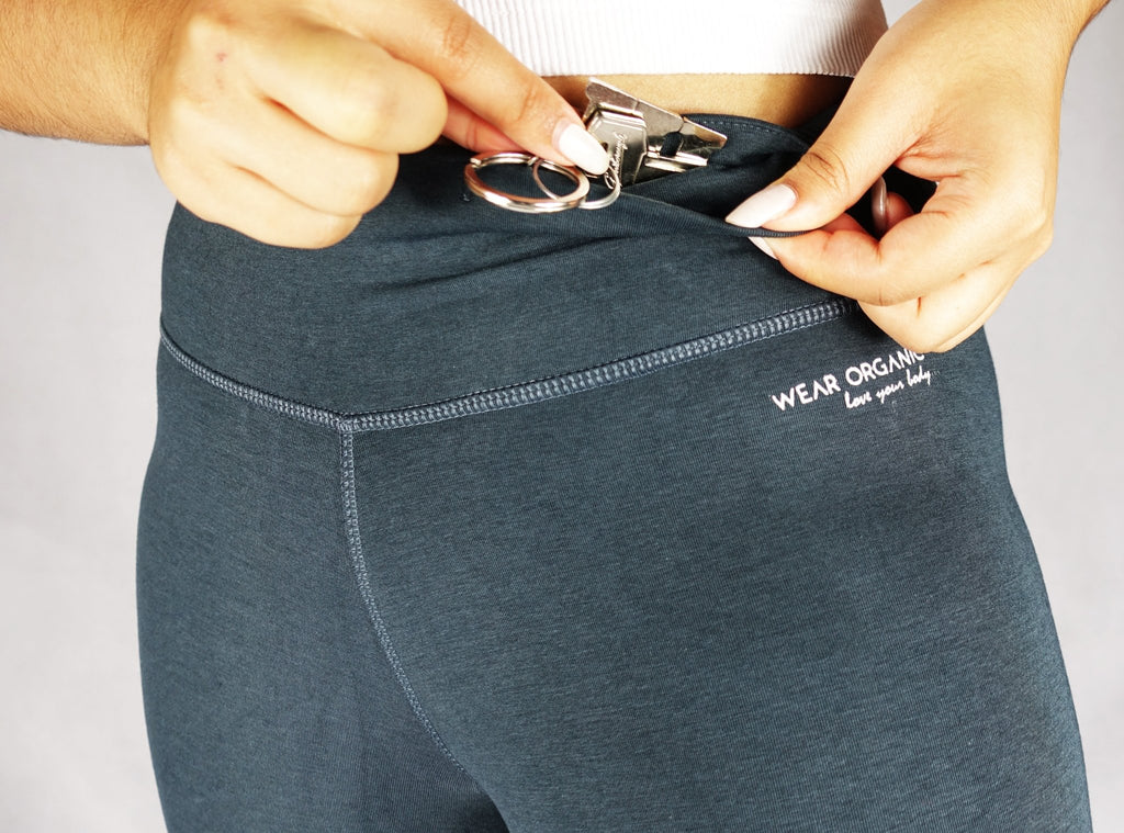Gunmetal grey crop leggings with a view of hidden pocket in the front waistband