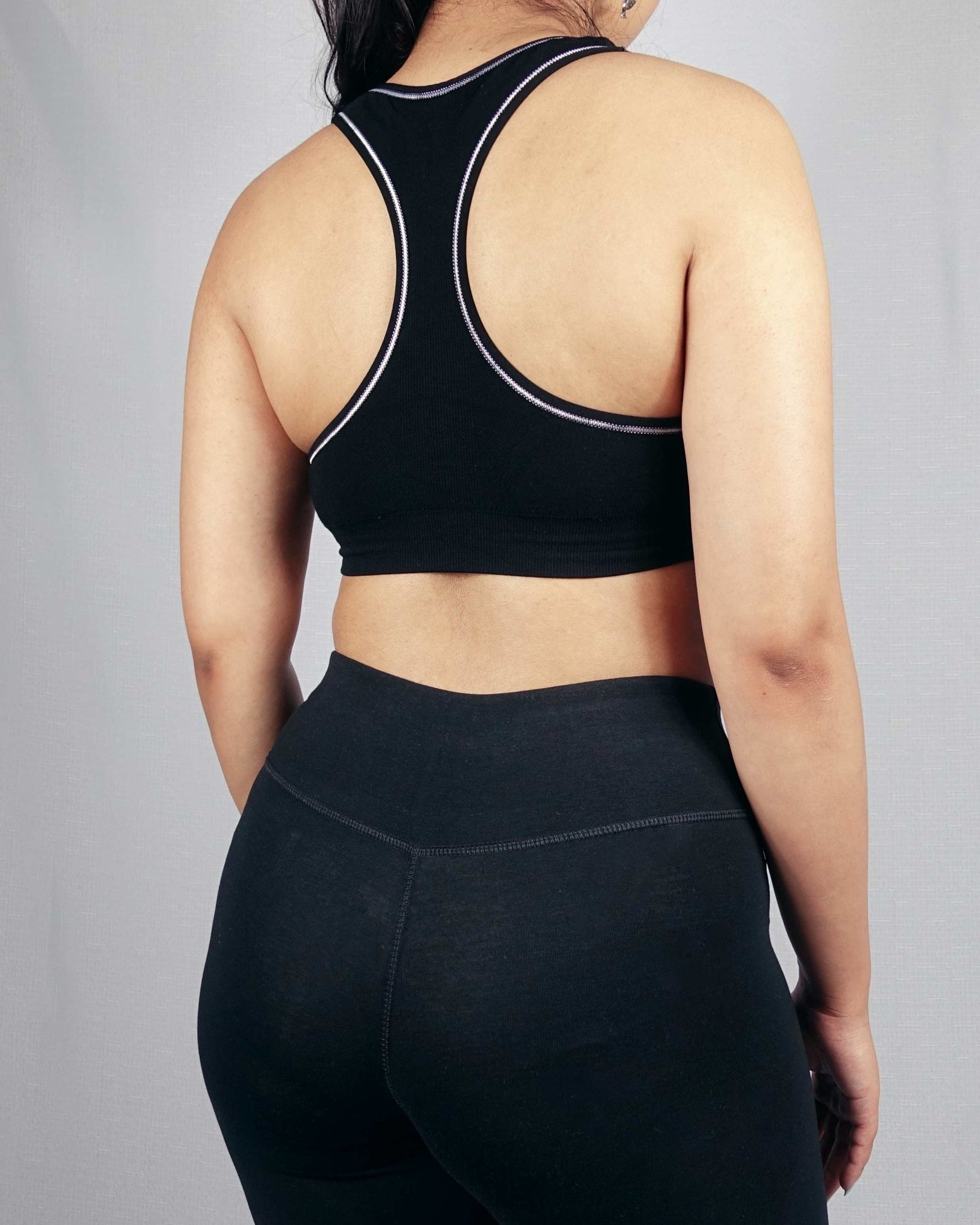Back view of black padded soft ribbed sports bra