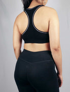 Back view of black padded soft ribbed sports bra