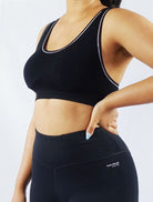 Model wearing black padded soft ribbed sports bra