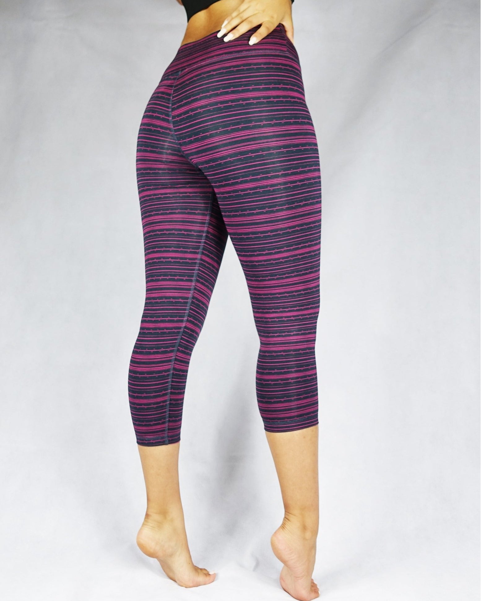 Pink stripe on black crop leggings, side view