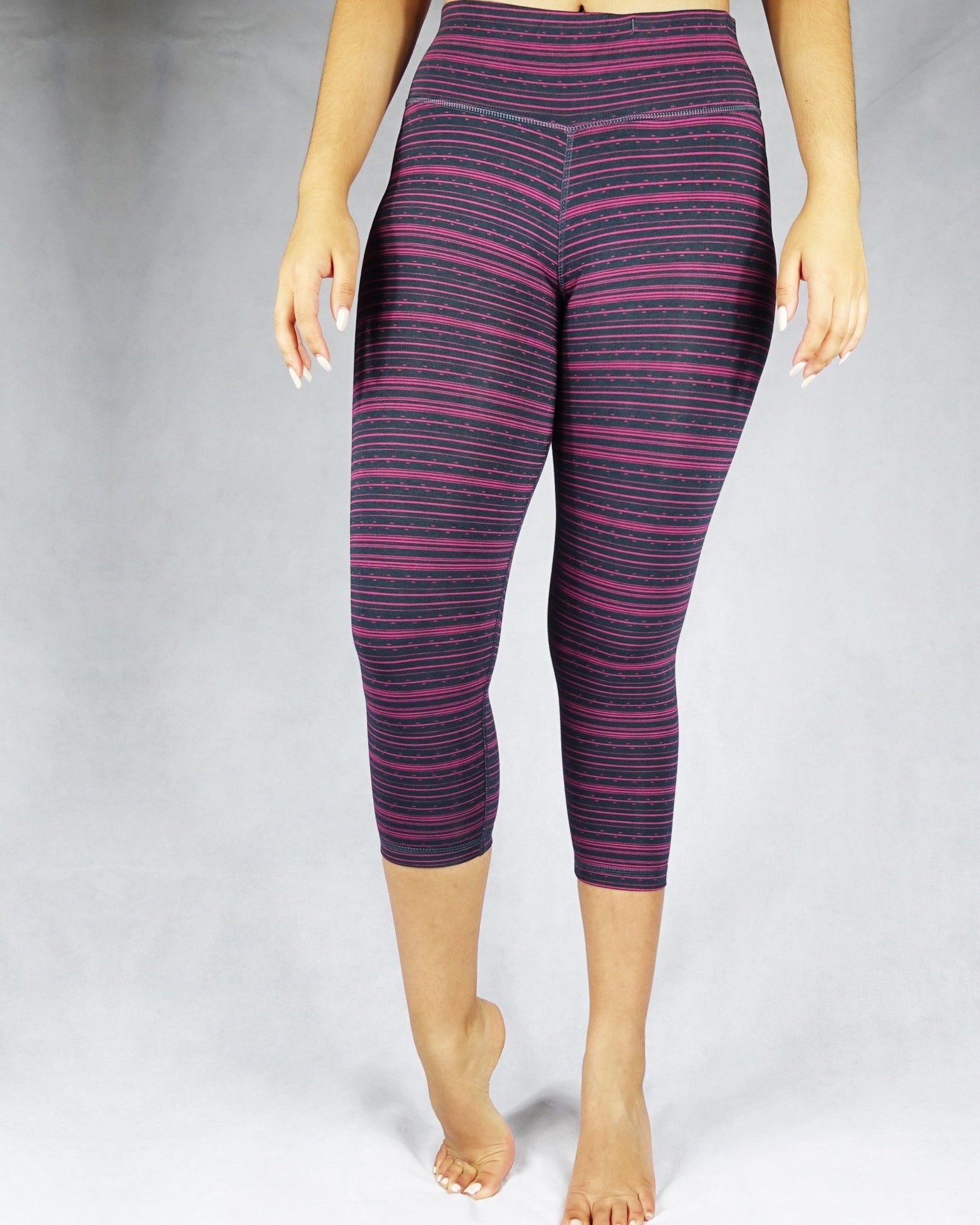 Front view of pink stripe on black crop leggings
