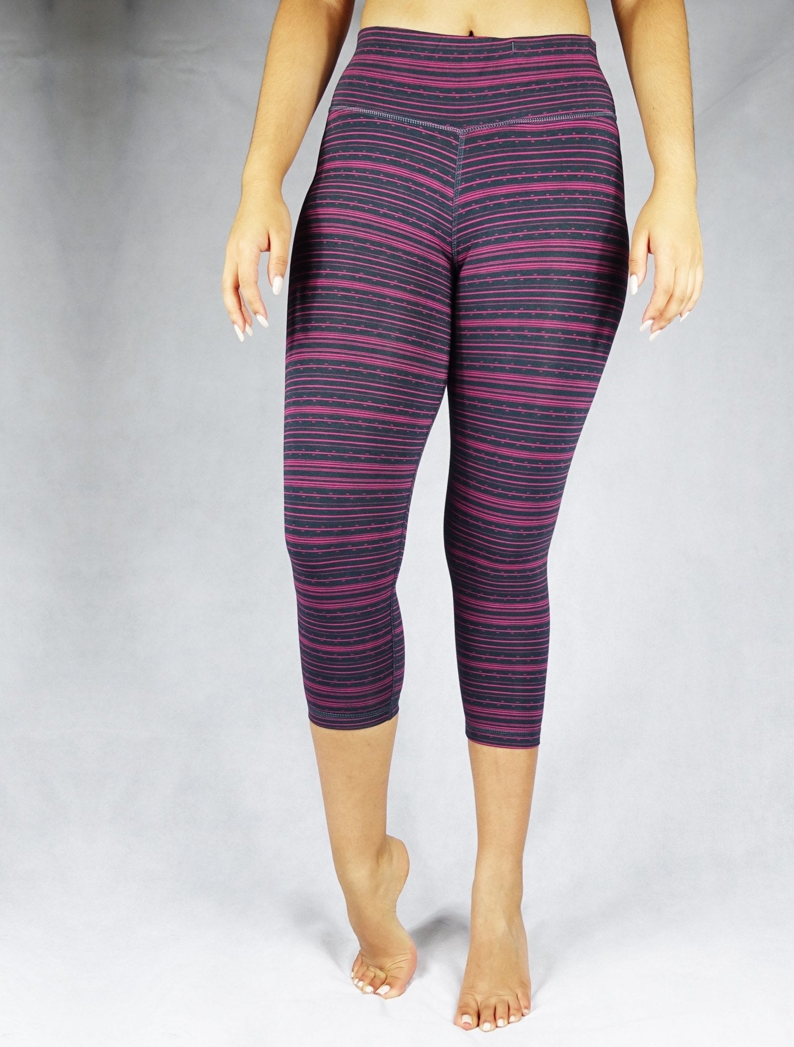 Front view of pink stripe on black crop leggings