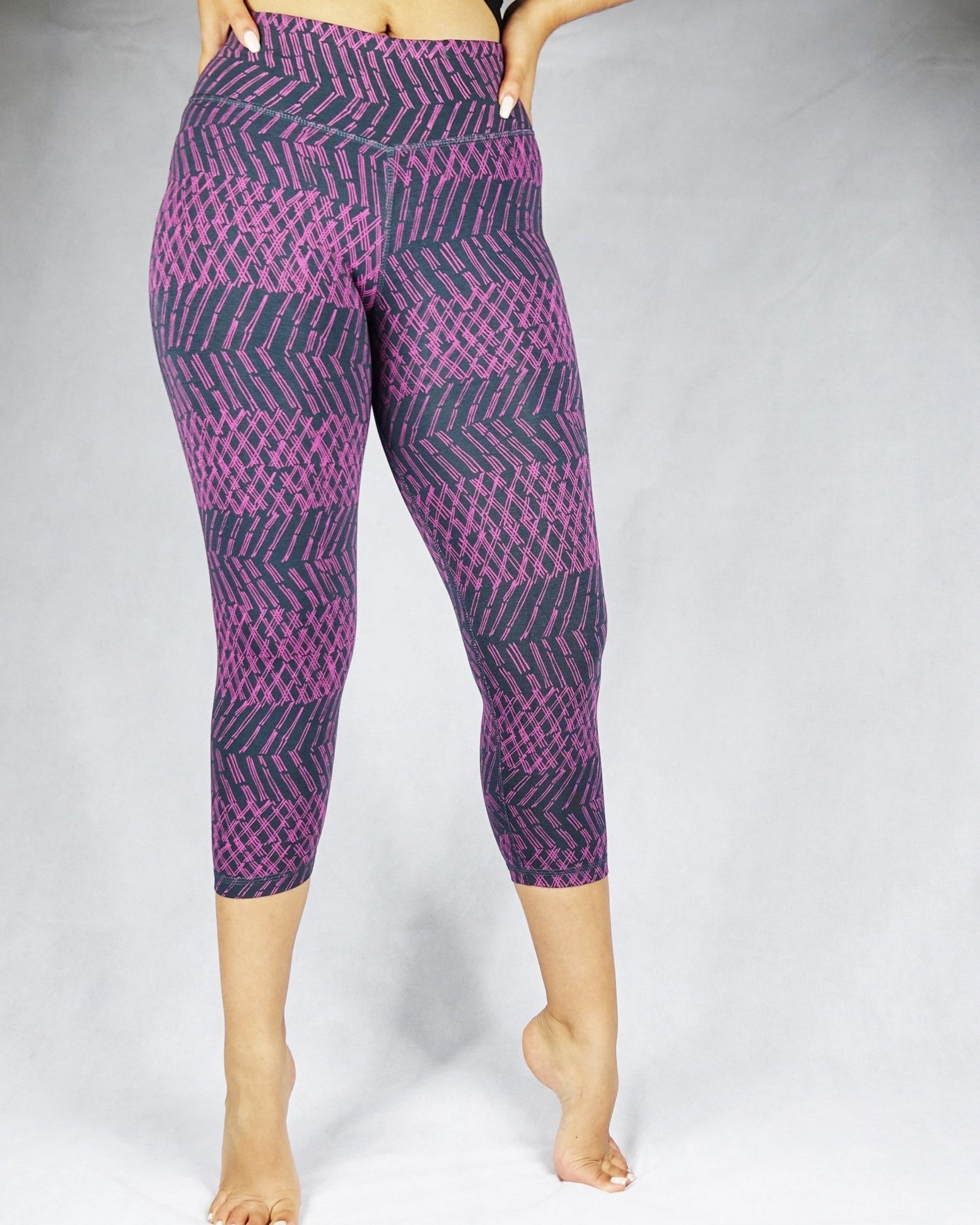 Model wearing plum patterned colour crop leggings