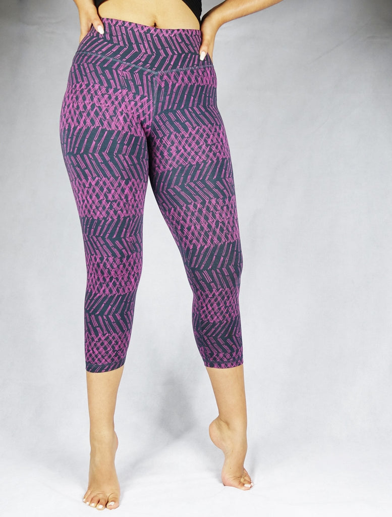 Model wearing plum patterned colour crop leggings