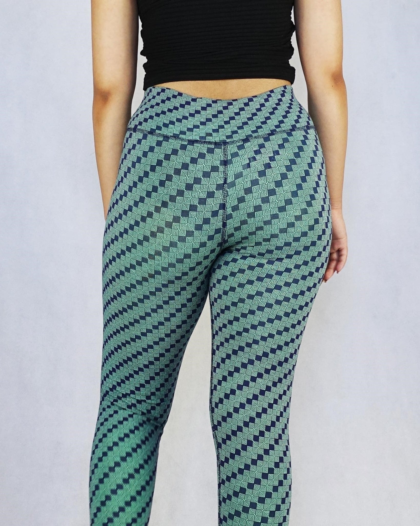 Back view of model wearing green patterned colour full length leggings