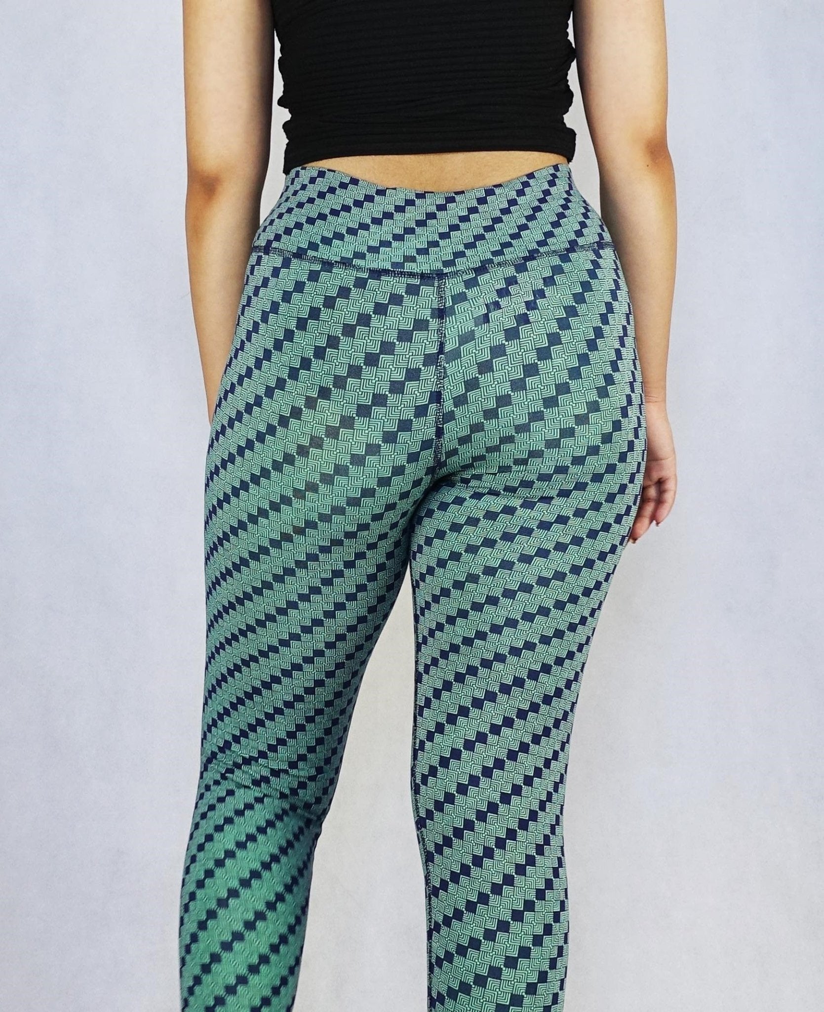 Back view of model wearing green patterned colour full length leggings