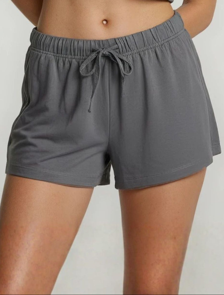 Woman wearing a gray bamboo super soft shorts on a white background