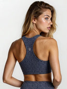Woman wearing a blue patterned  bamboo super soft high impact sports bra on a white background