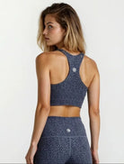 Woman wearing a blue patterned sports bra  Sports Bra &amp; Ankle Length Leggings, now available as a value-packed bundle  on a white background